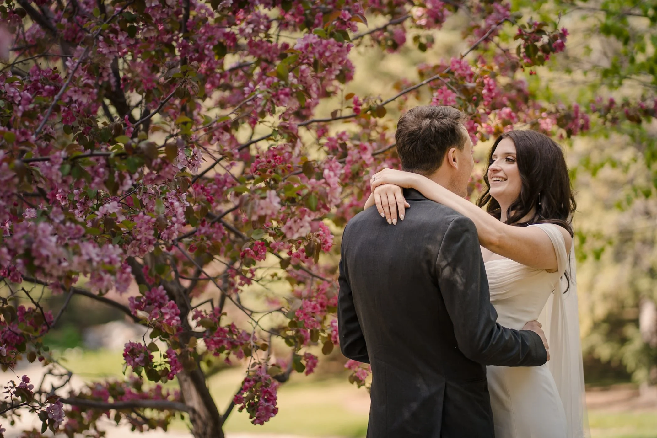 bride and groom in springtime cherry blossoms at university of Alberta Botanic gardens