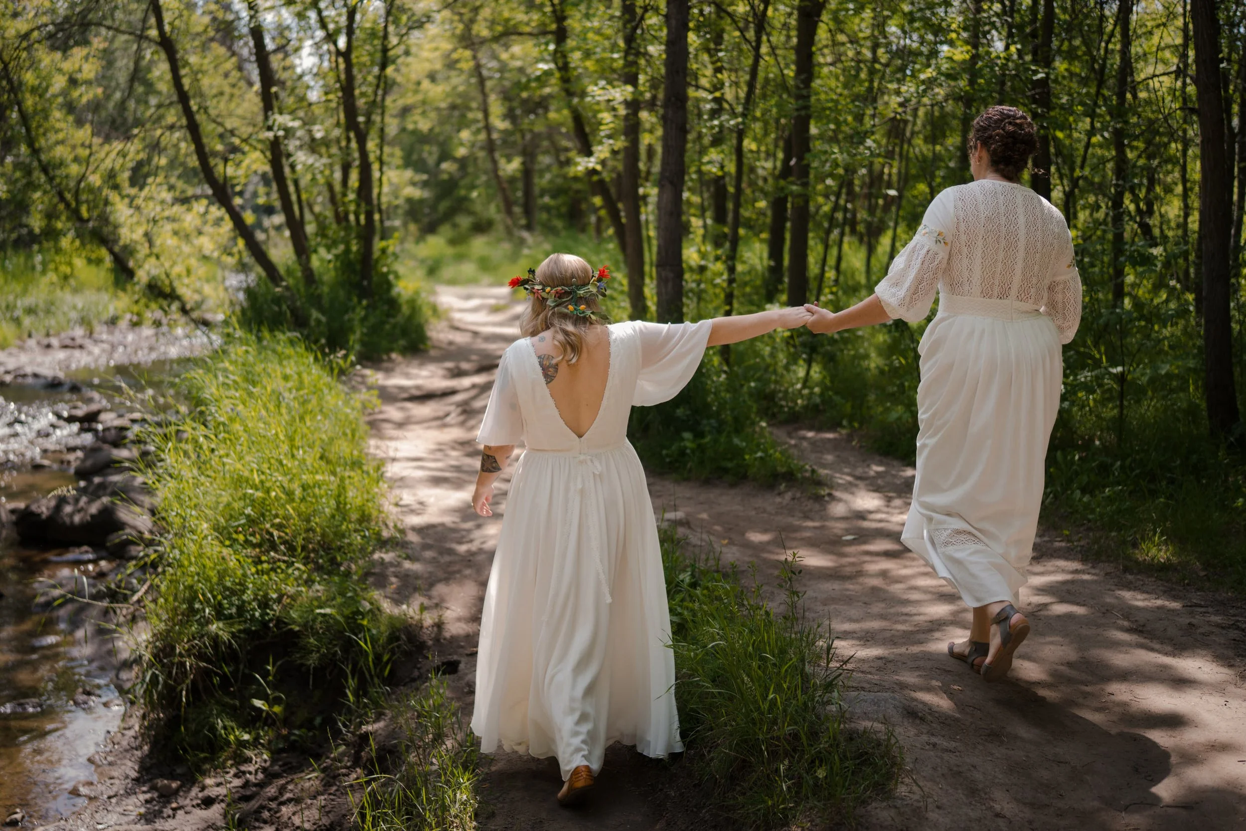 lesbian-brides-dresses-walking-meadow.jpg