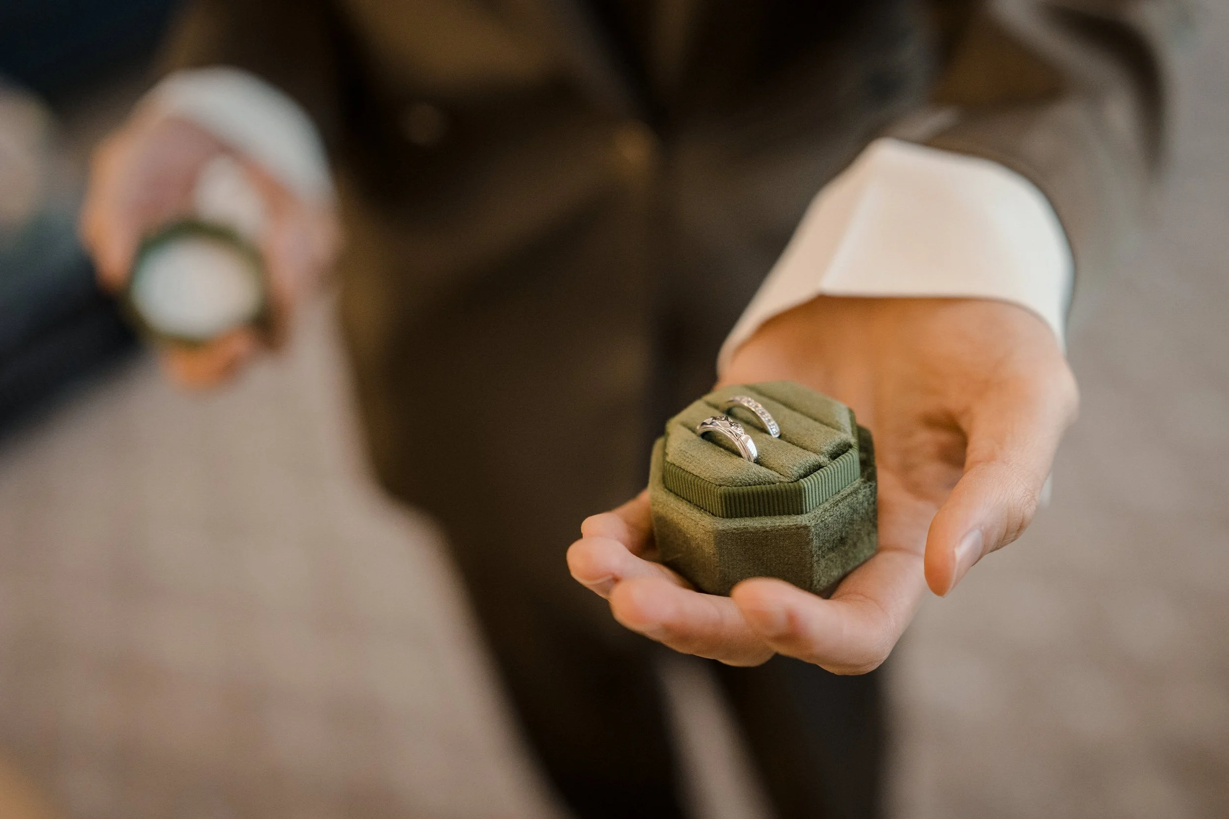antique wedding bands in a green velvet box detail photo at Enjoy center