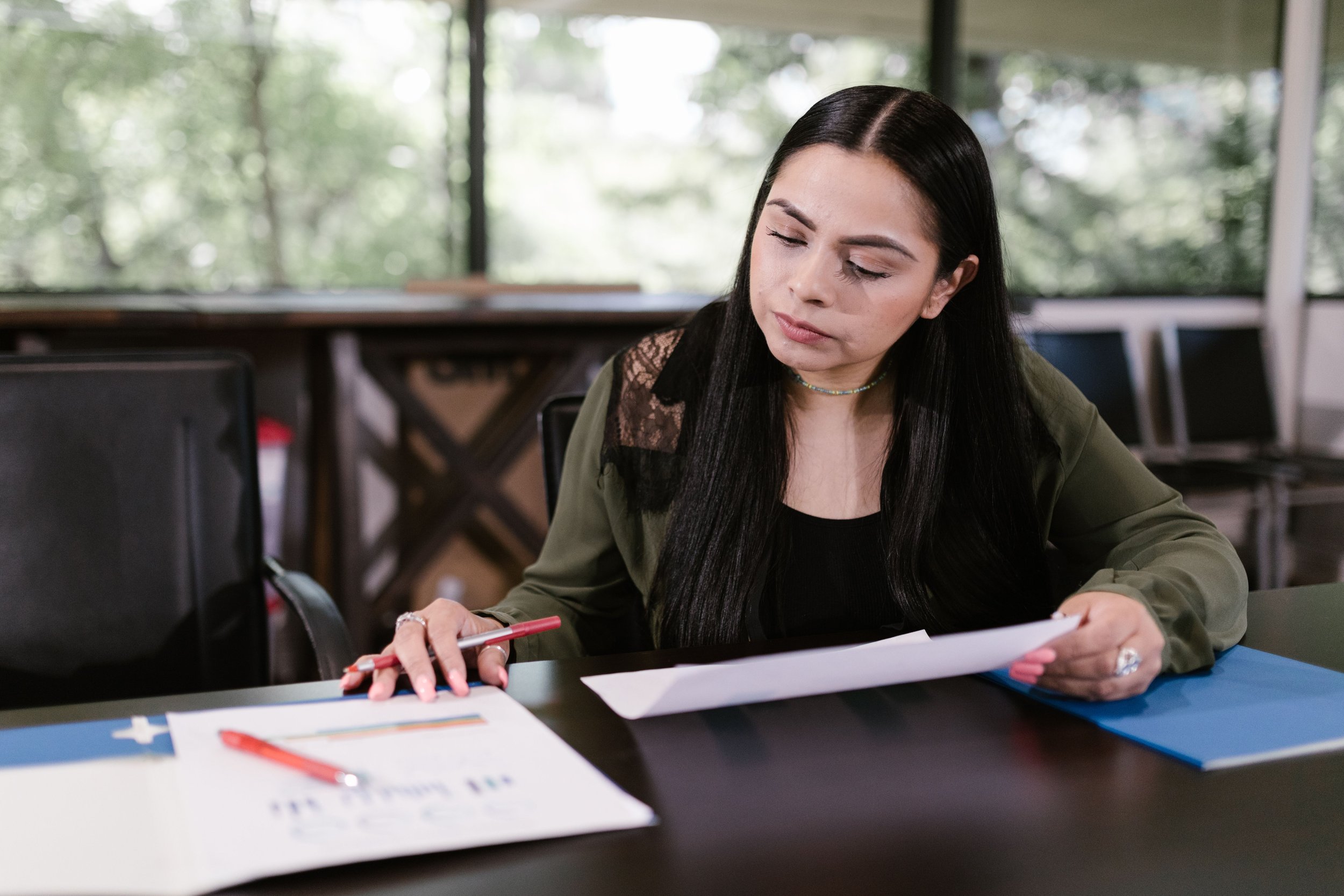 a person sitting on a desk reading documents