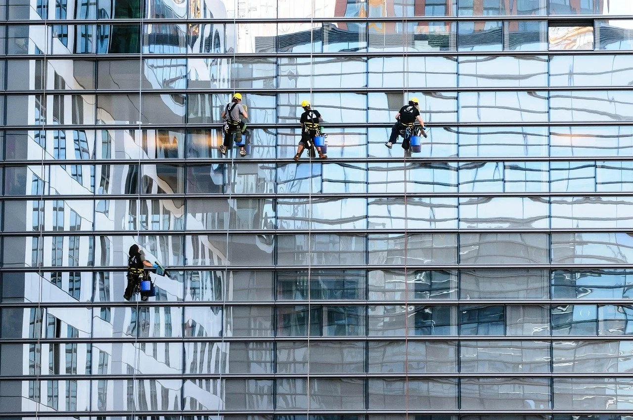 workers cleaning the glass of a high rise building