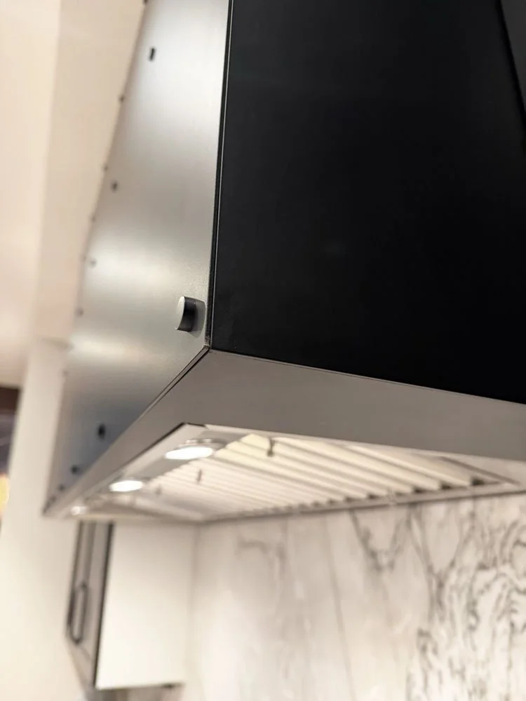 Close-up of oven hood precision welds and hand-finished steel surface