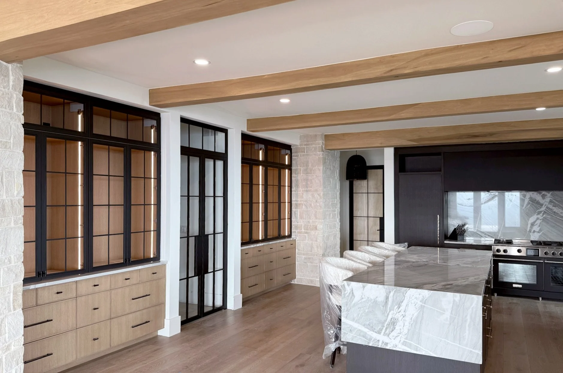 Custom steel pivot doors and cabinets installed in modern luxury home in Golden