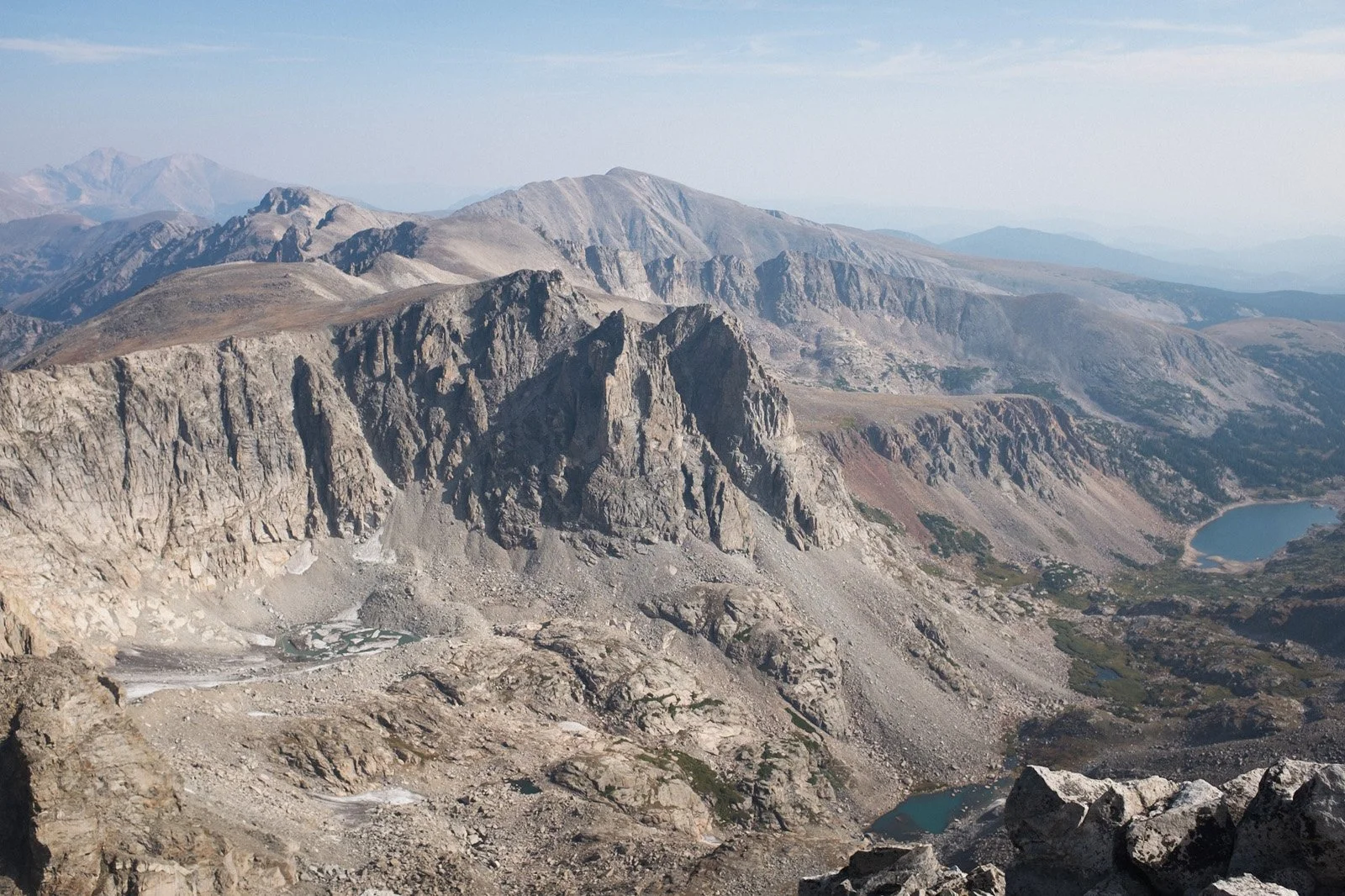 On the summit of Navajo Peak looking north-northeast. Longs Peak is visible in the left corner and Lake Isabelle is below (September 2021).