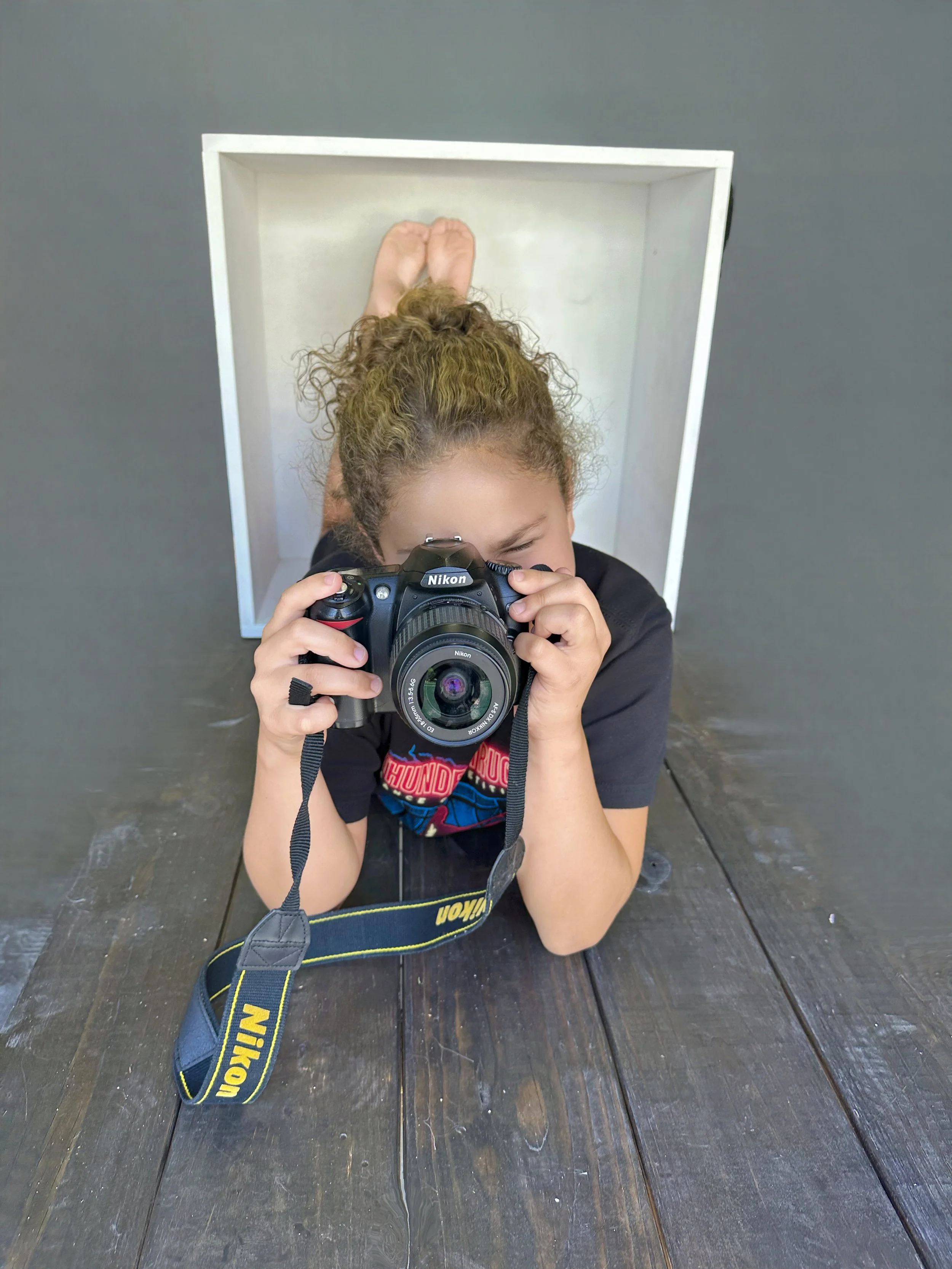 Laurie’s customers, Mariana and Carmen holding hands on a green lawn on their wedding day.