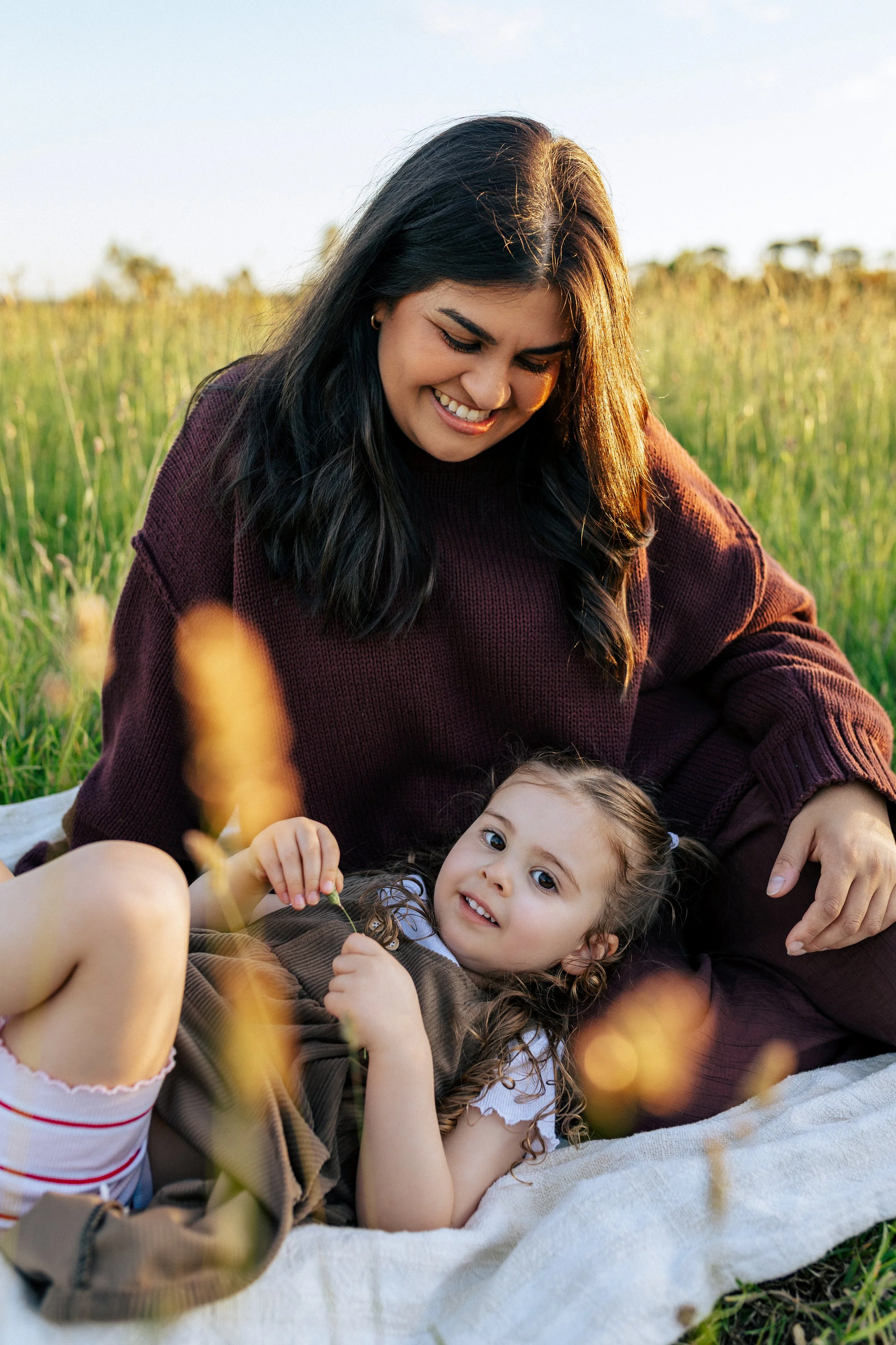 Mother and children sharing a quiet moment during an outdoor family session.