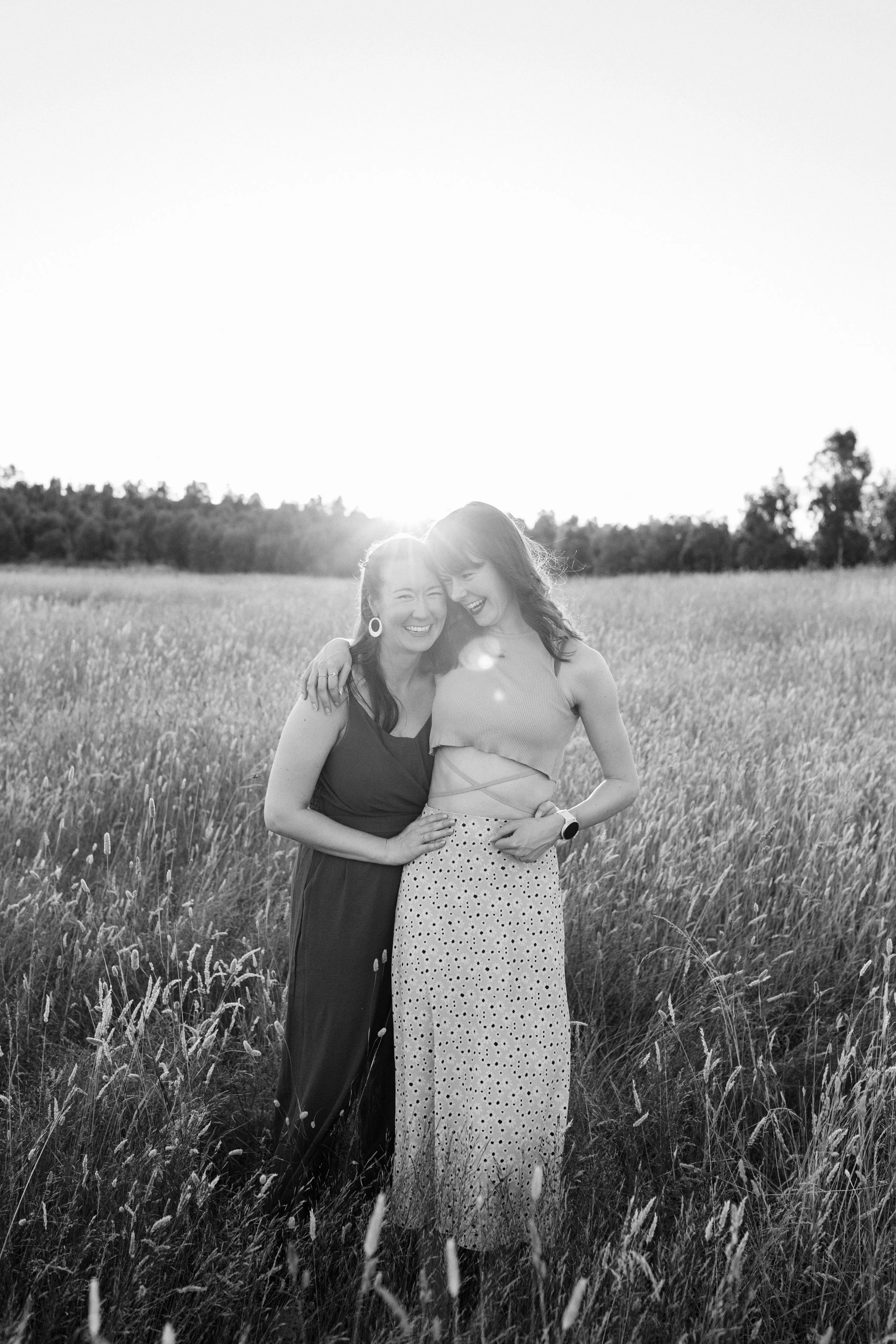 Sisters laughing and embracing during outdoor photo session in Melbourne