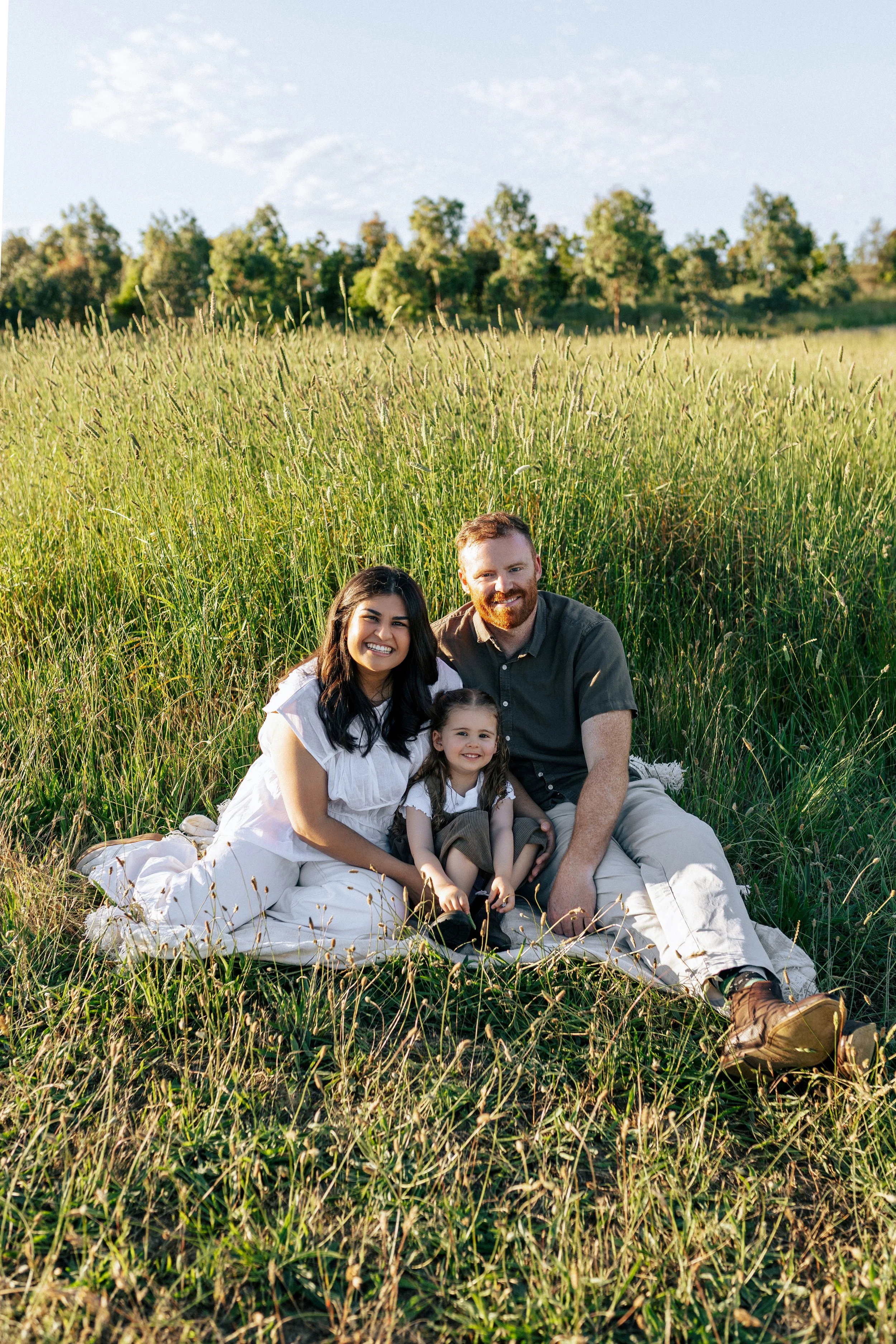 Family sitting together at sunset