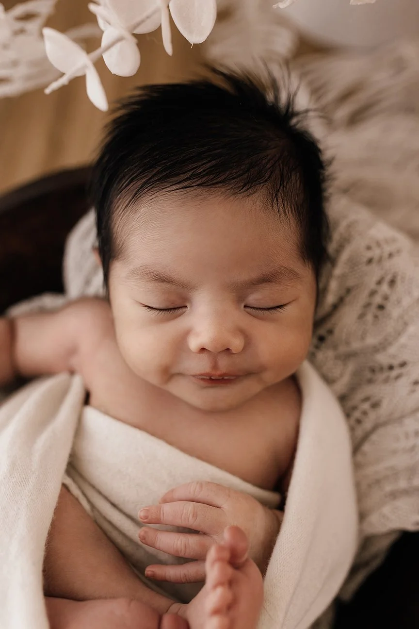 Close-up of a newborn baby's eyelashes and delicate features.
