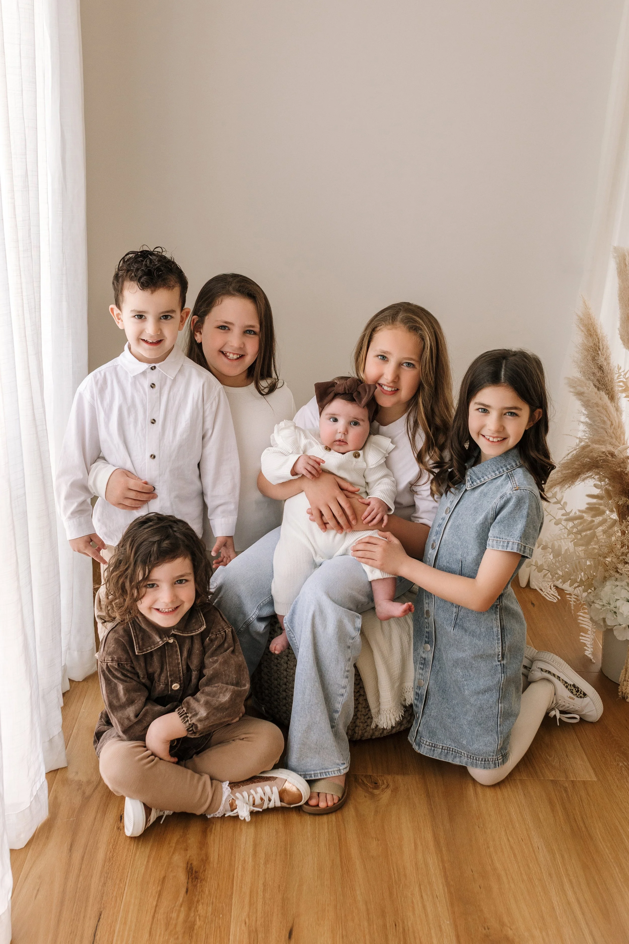 Siblings cuddling together during a family photography session.