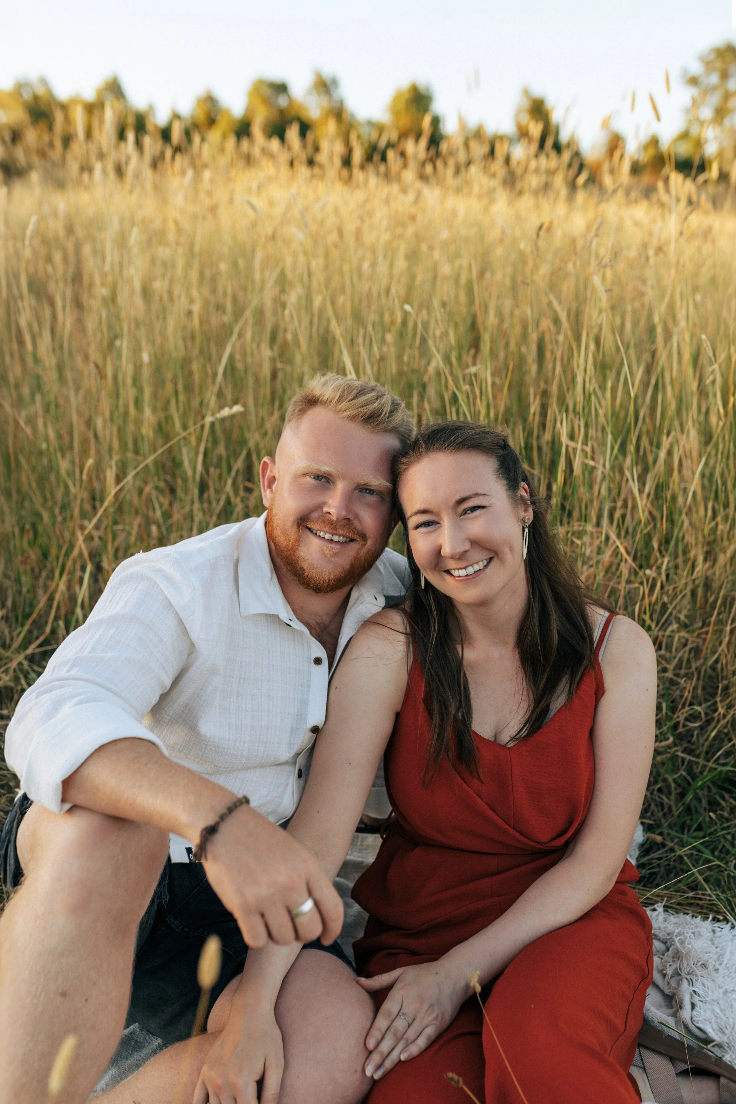 Couple embracing during a relaxed outdoor photography session.
