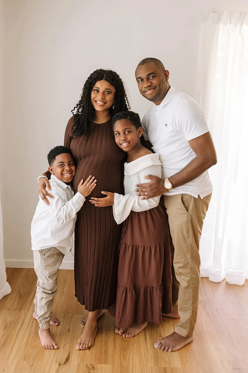 Mother-to-be and family during a studio maternity photoshoot.