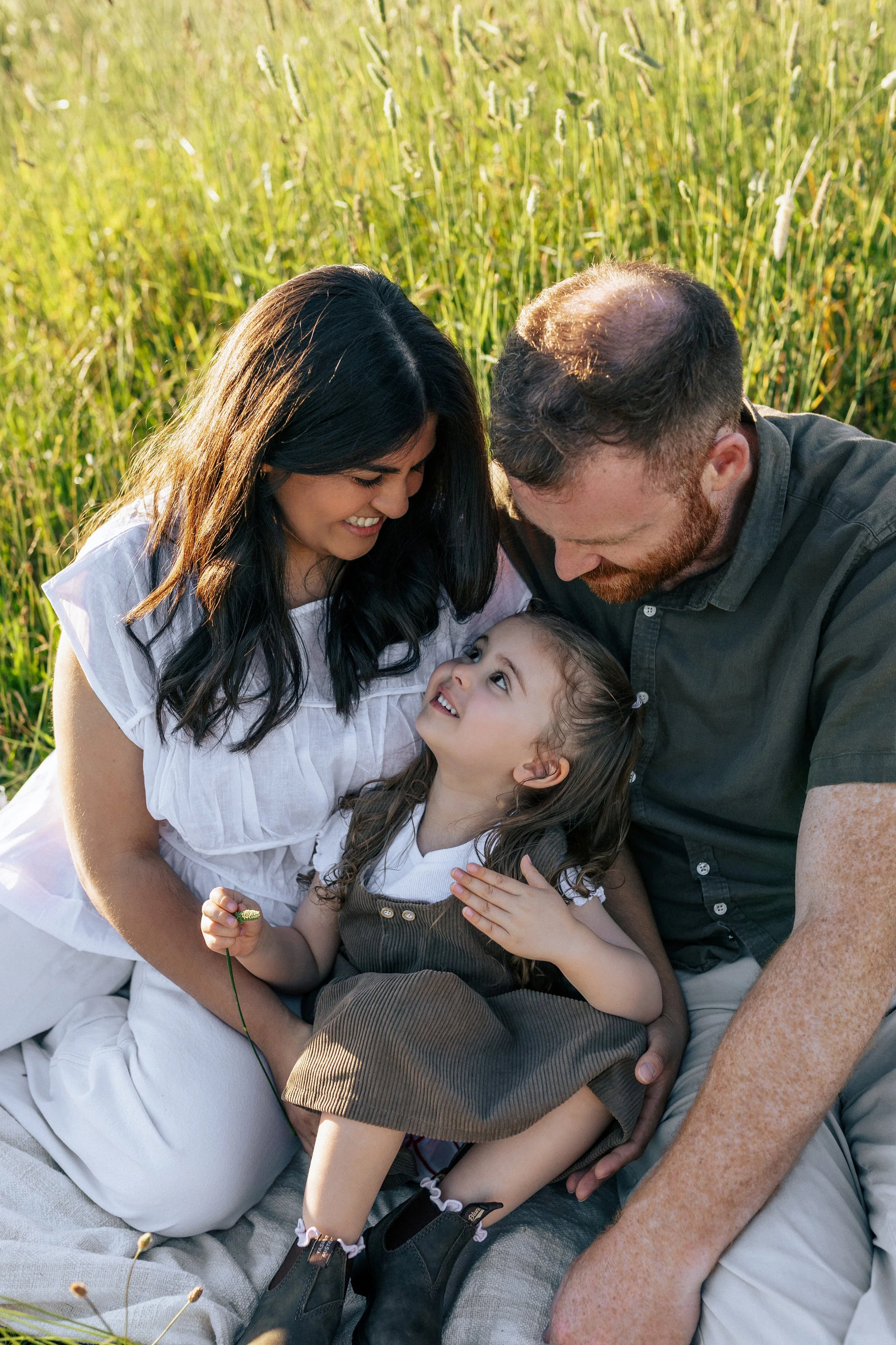 Family embracing during a relaxed outdoor photography session