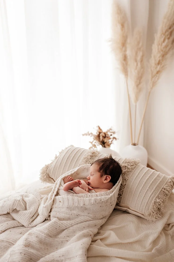 Natural newborn portrait captured in a warm studio setting.