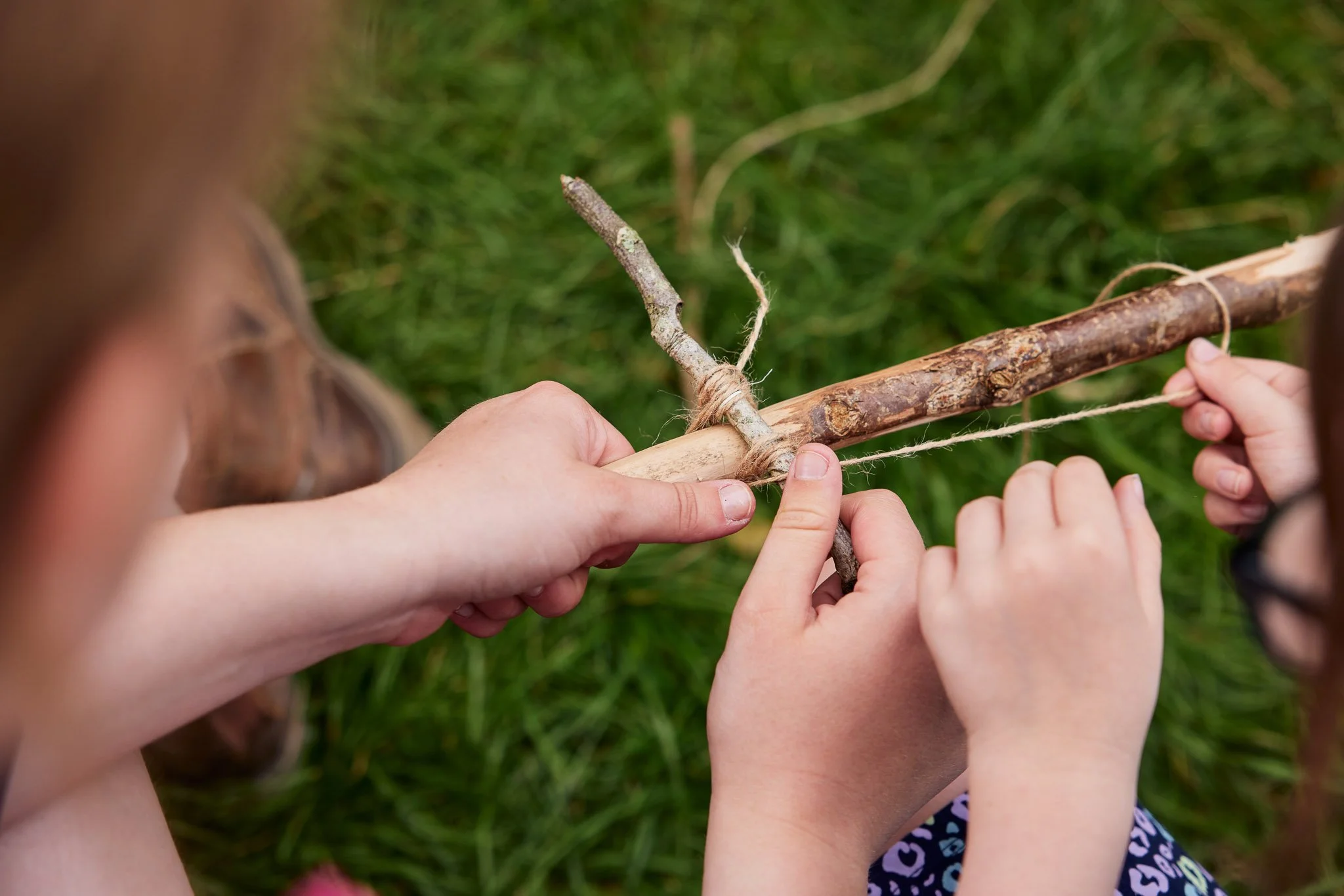 childens hands making a bow
