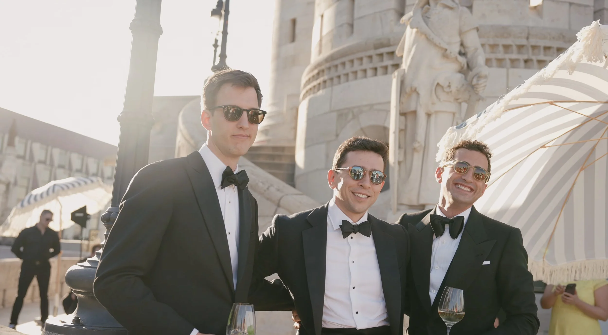 Groom and groomsmen in tuxedos on a terrace of the Fisherman's Bastion in Budapest, wedding film by Closer Wedding Studio