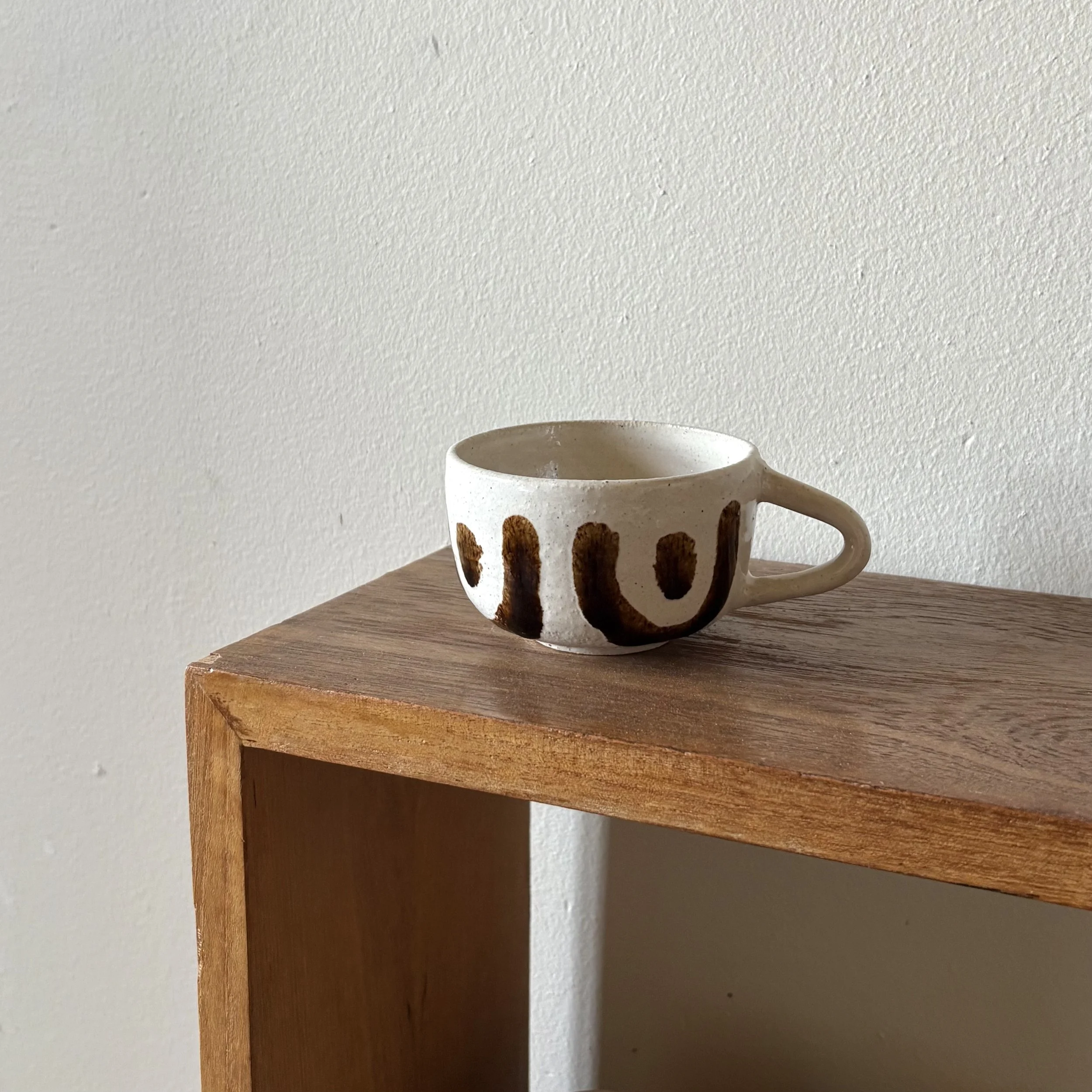 frank coffee cup on shelve.jpg