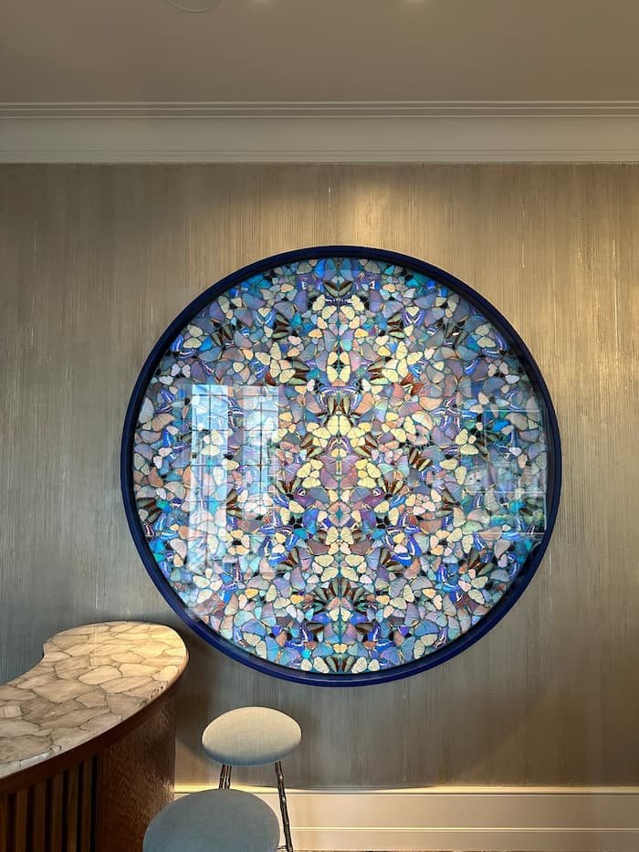 Professional picture hanging by Gilbert Art Services in a luxury Holland Park townhouse, artwork by Damien Hirst