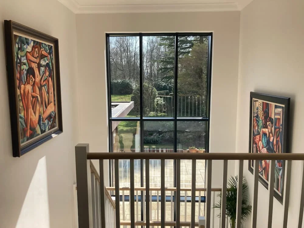 Picture hanging on staircase in Surrey home.