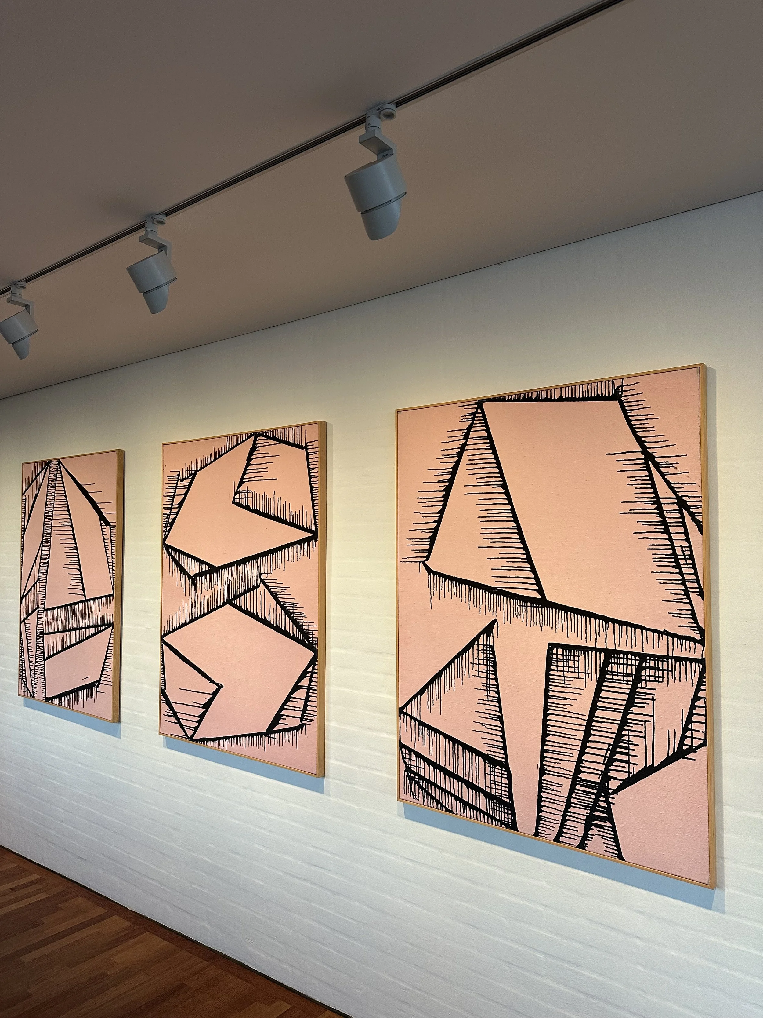 Artwork installed on white brick wall