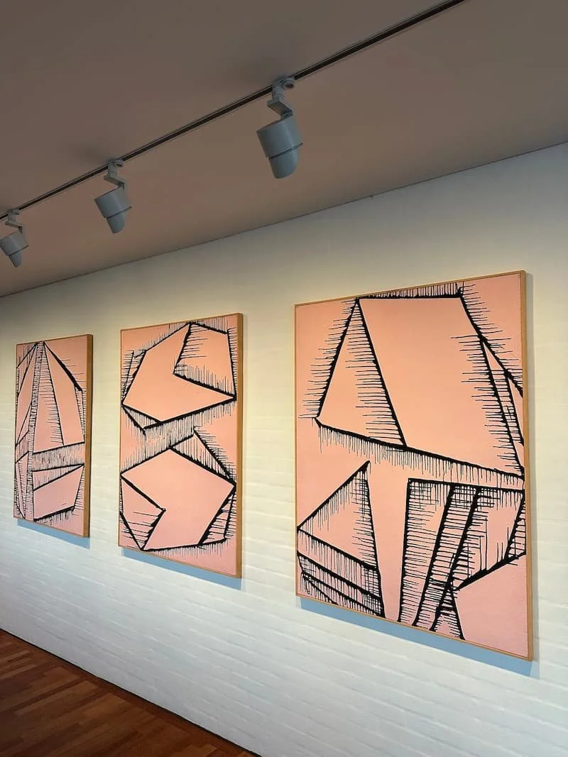 Expert art hanging for a commercial gallery space in Mayfair, featuring perfectly aligned artworks and lighting..