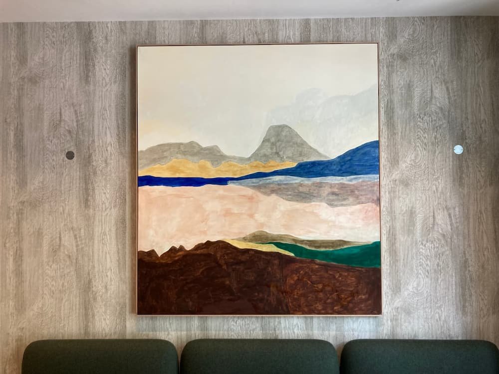 Professional picture hanging by Gilbert Art Services in a Soho office foyer.