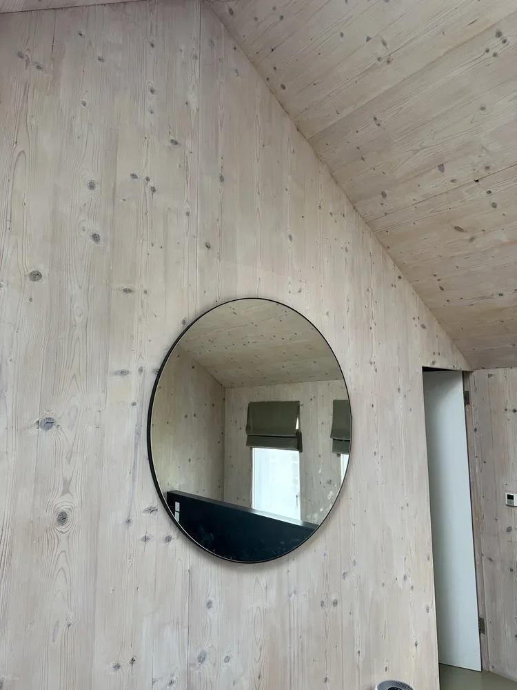 A circular mirror professional hung by gilbert art services in hackney