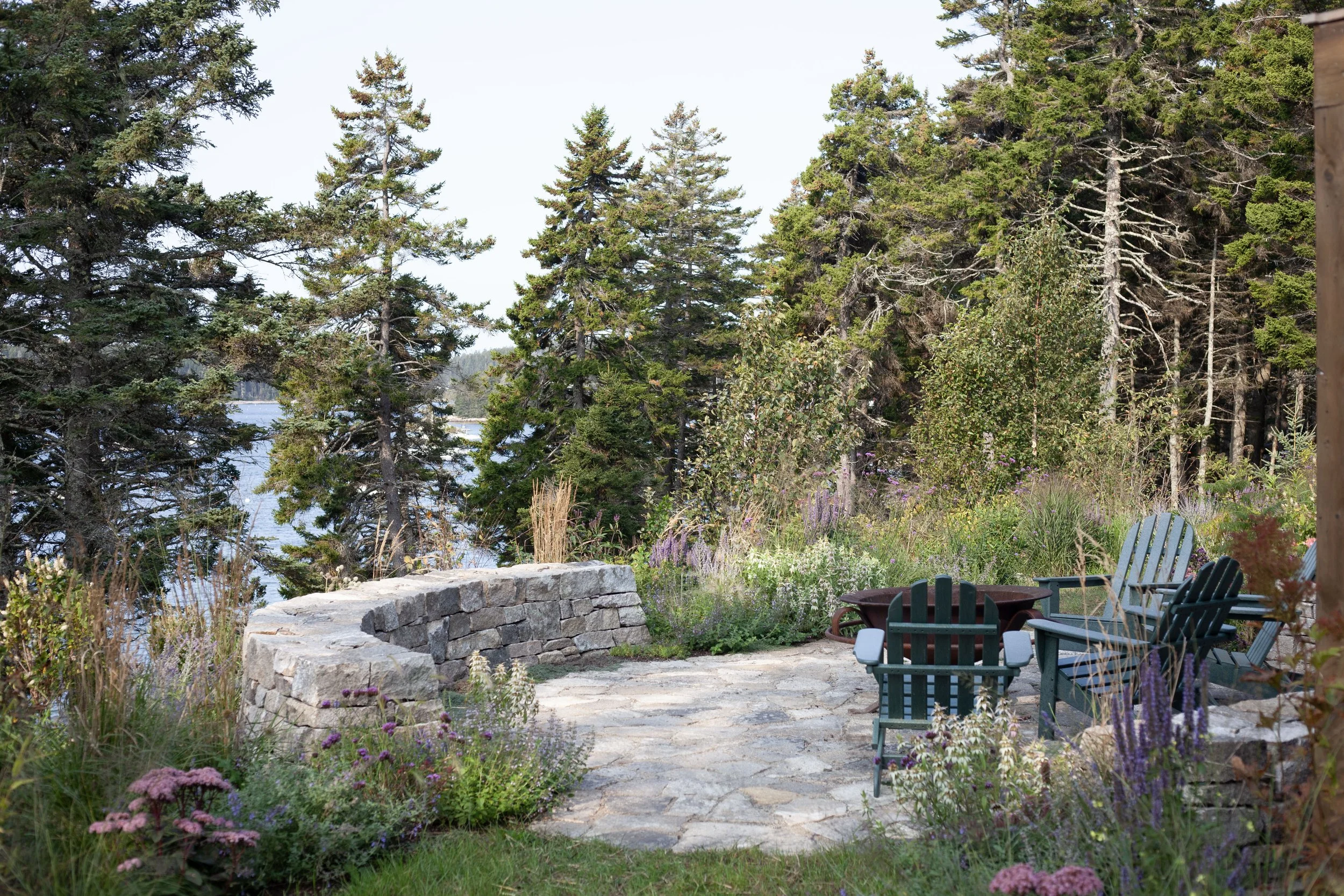 Fire pit and gardens overlook Burnt Coat Harbor on Swan’s Island.