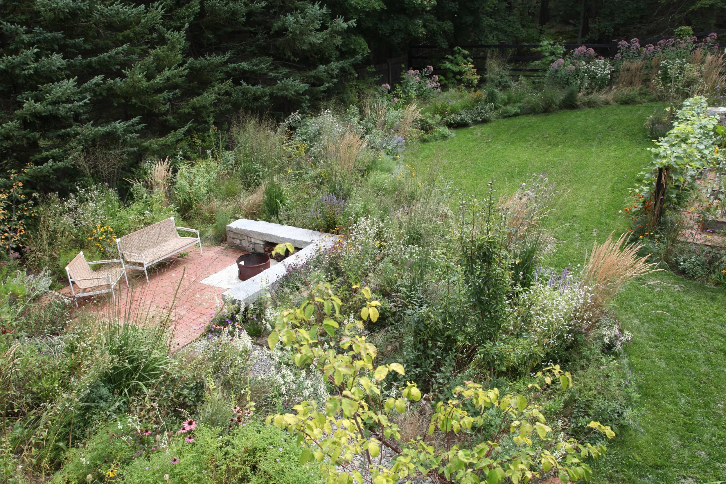 View of the garden and fire pit from the entrance porch. 