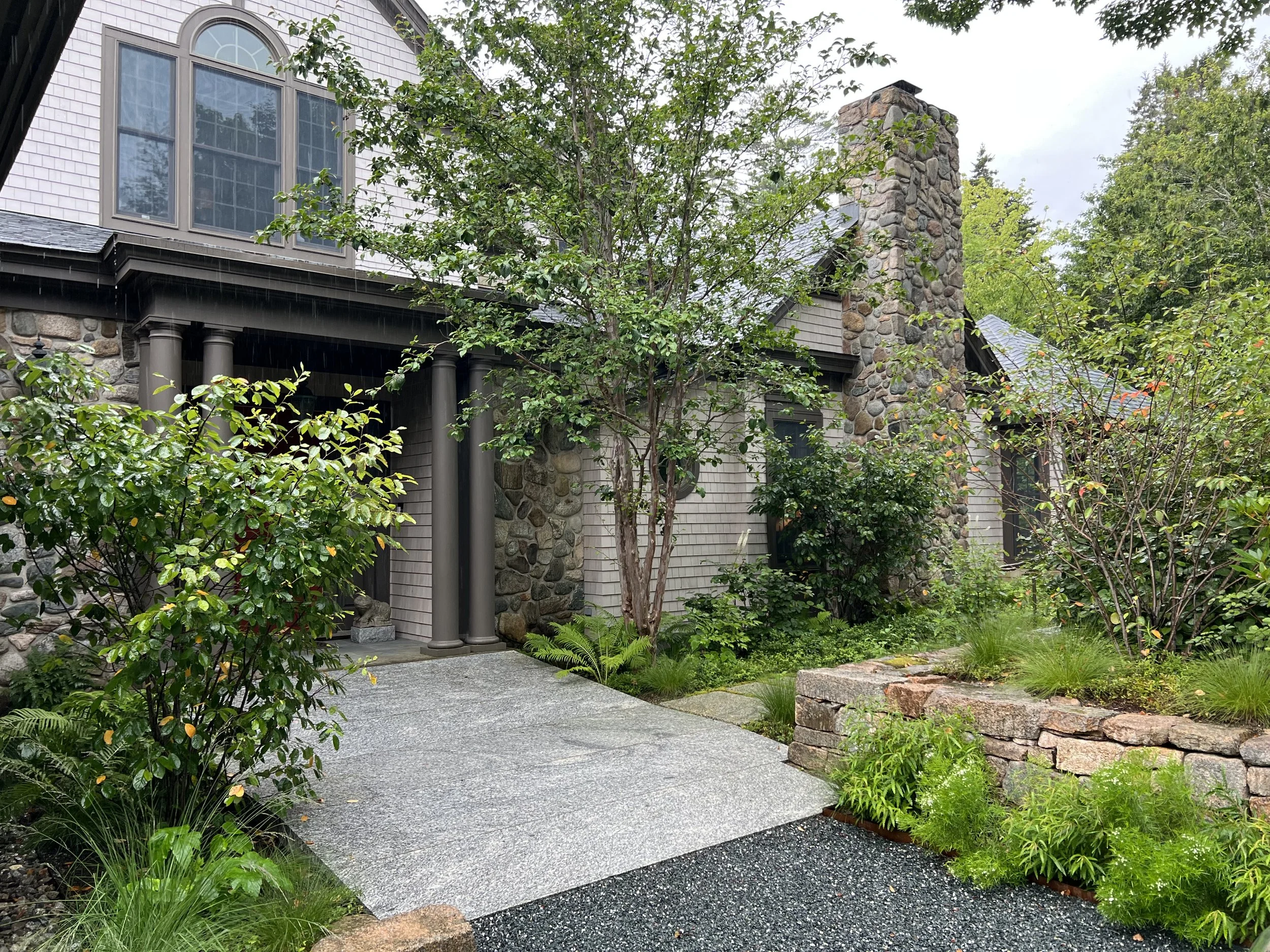 Generous house entrance with rebuilt walls, original Stewartia and new native plantings. 