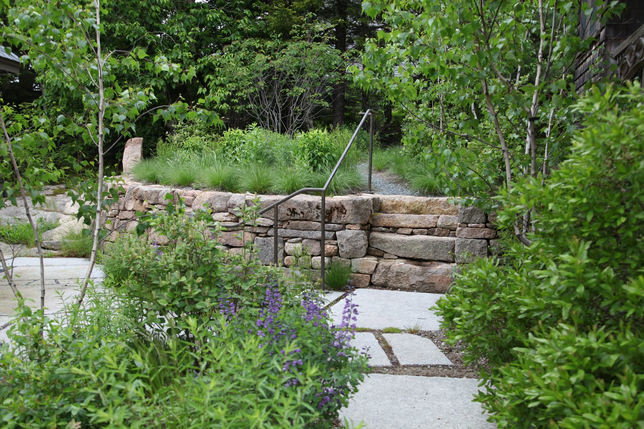 Upper garden terrace with local pink granite. 