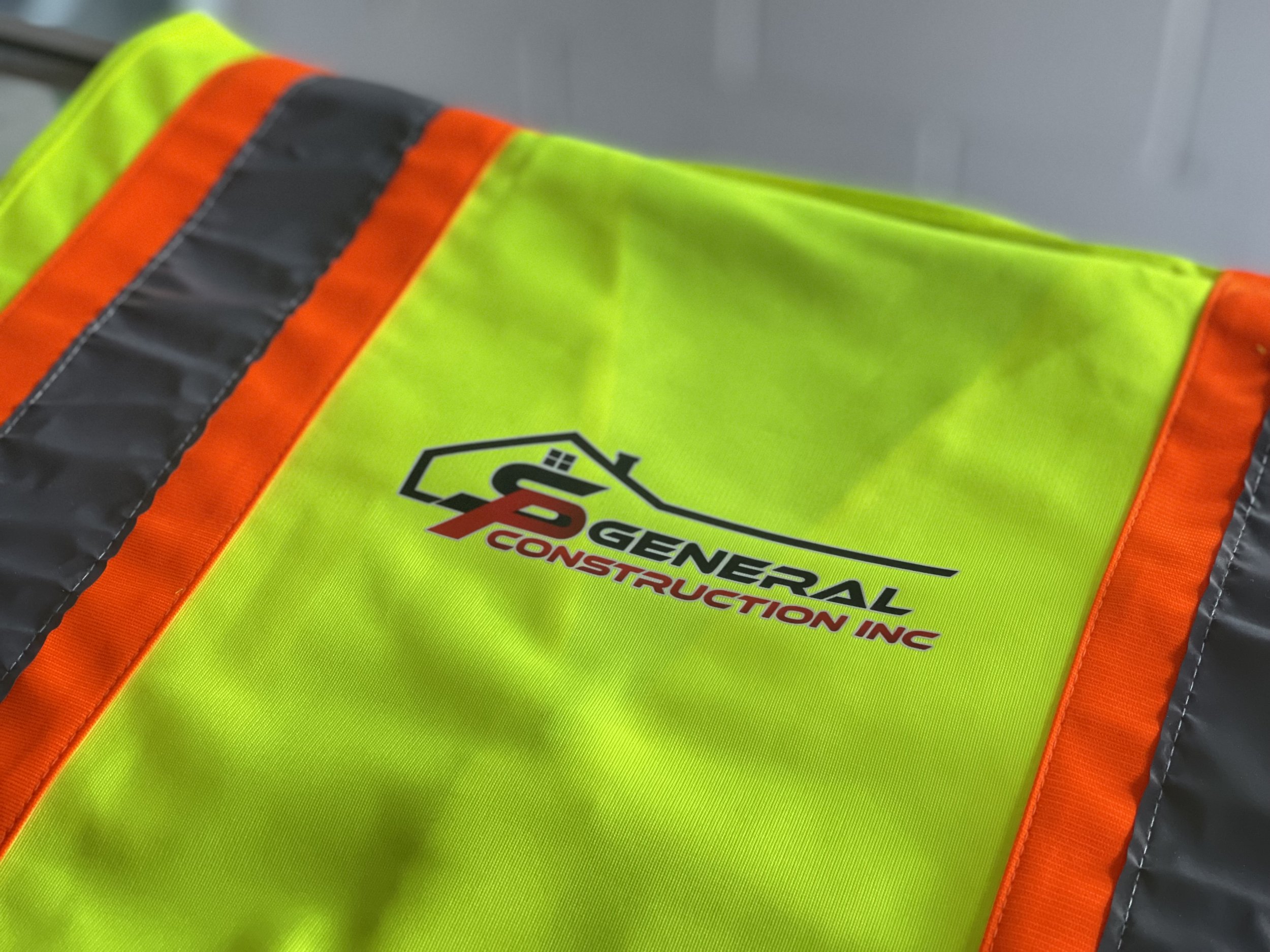 Direct to film heat transfer of SP General Construction inc on the back of a safety vest