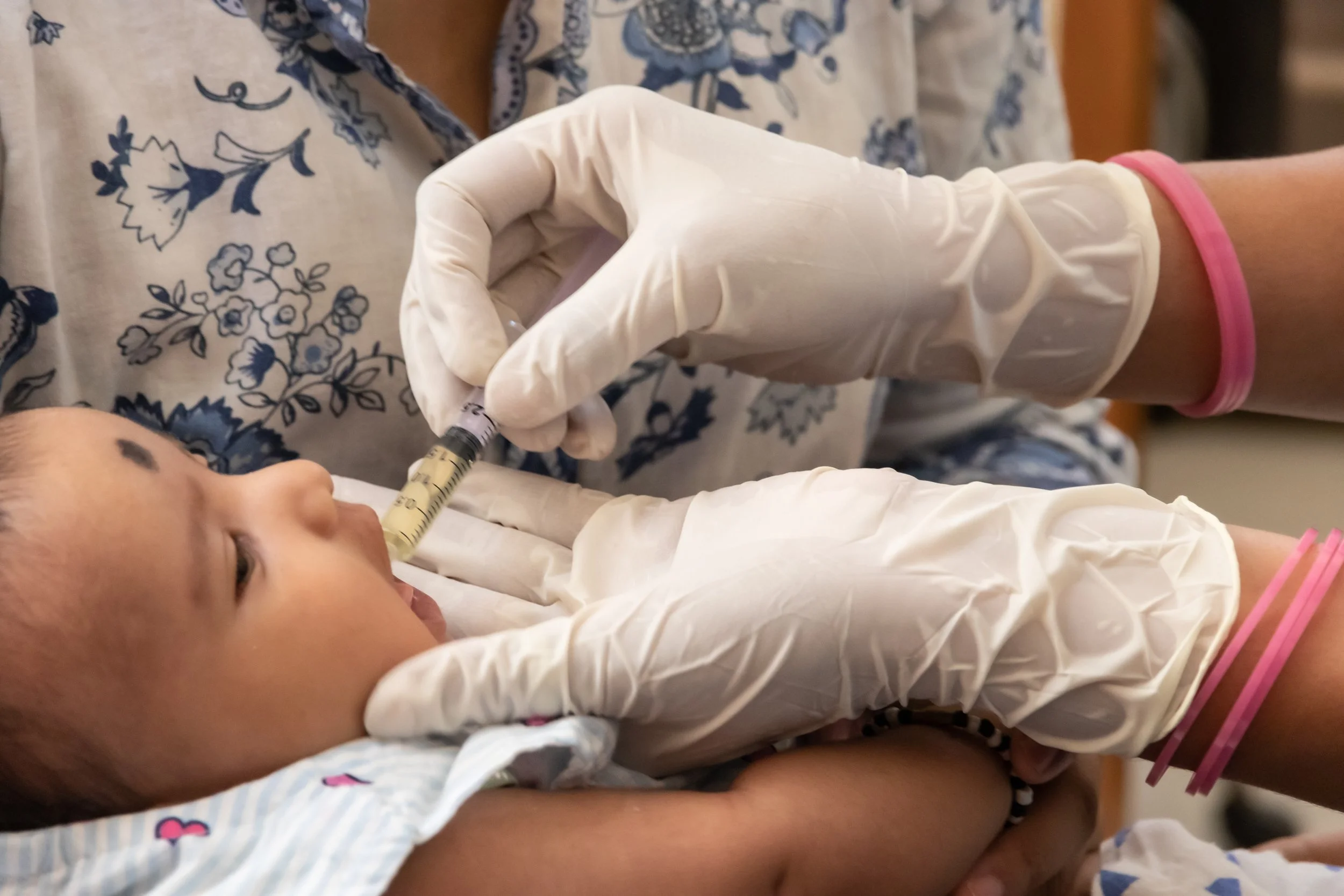  A health worker vaccinates a child at Urban Primary Health Centre., Gurugram, India. 