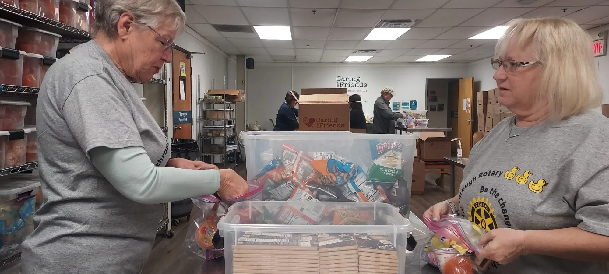Rotary volunteers packing snack bags for seniors at Caring for Friends