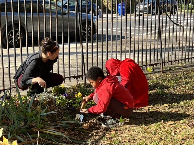 Chestnut Hill members working with students at Eleanor C. Emlen elementary school yard.