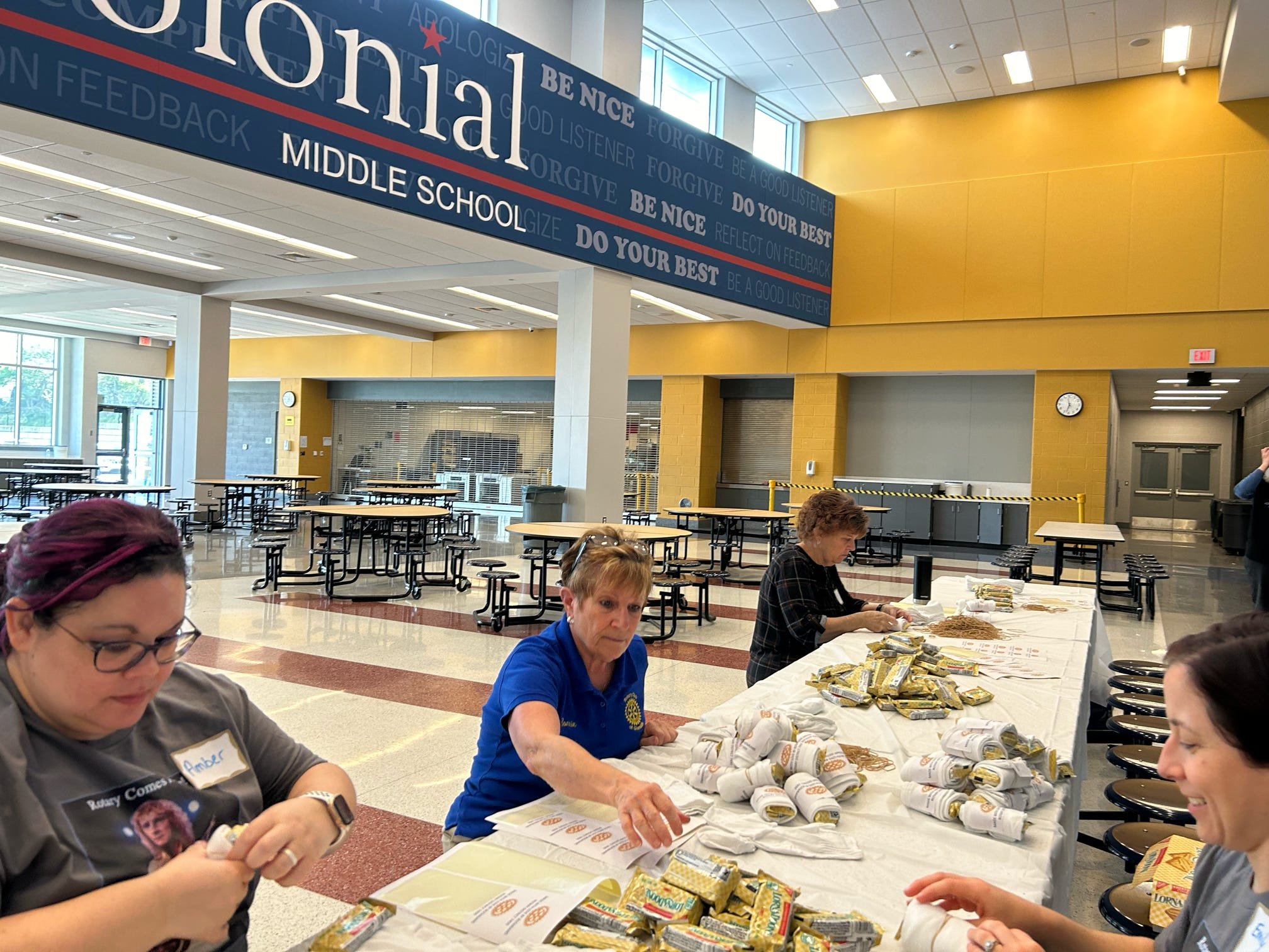 Volunteers preparing sock rolls and sandwiches for the unhoused as part of a District-wide service day.