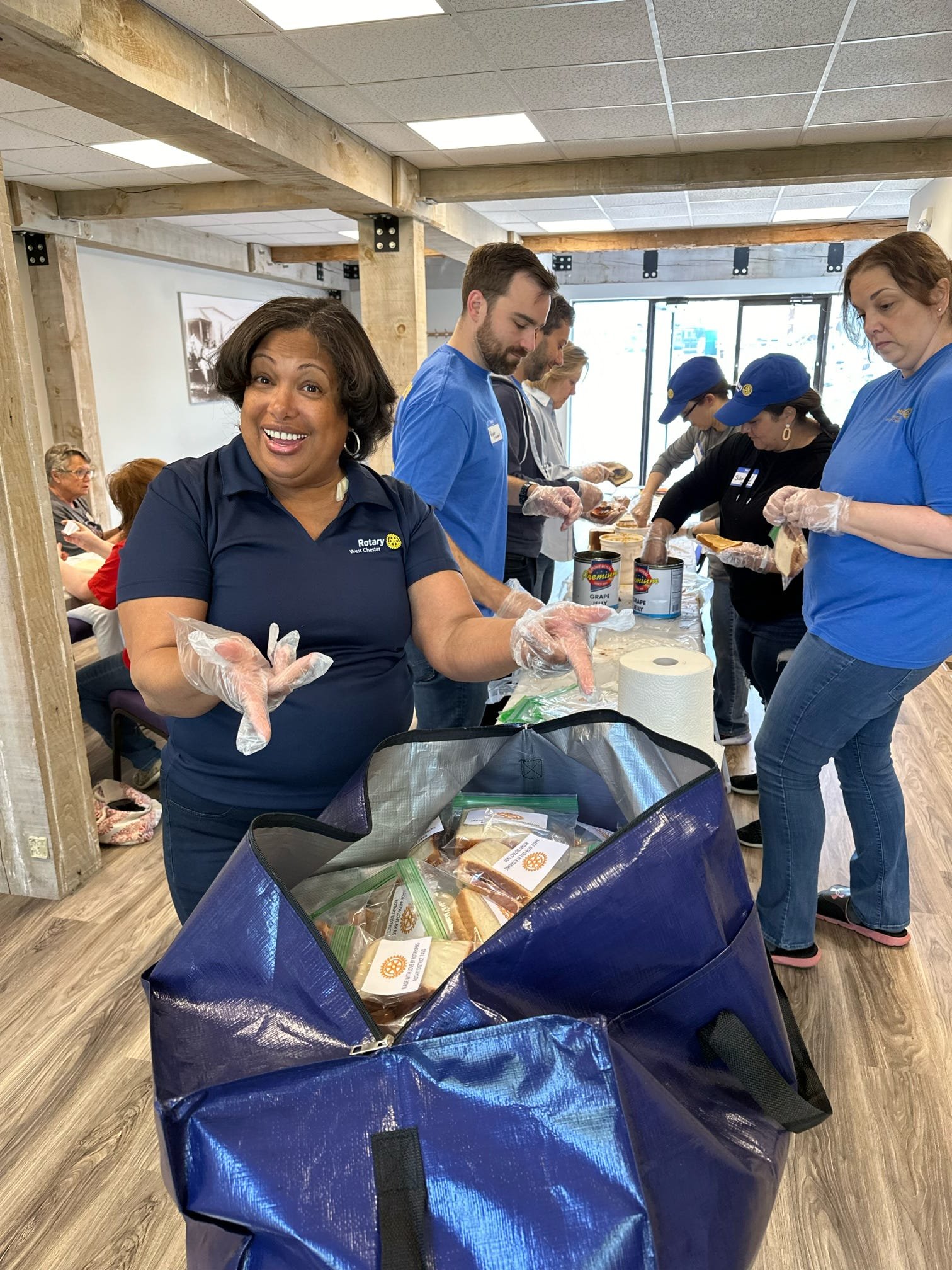 Volunteers packing sandwiches and other food items for the unhoused.