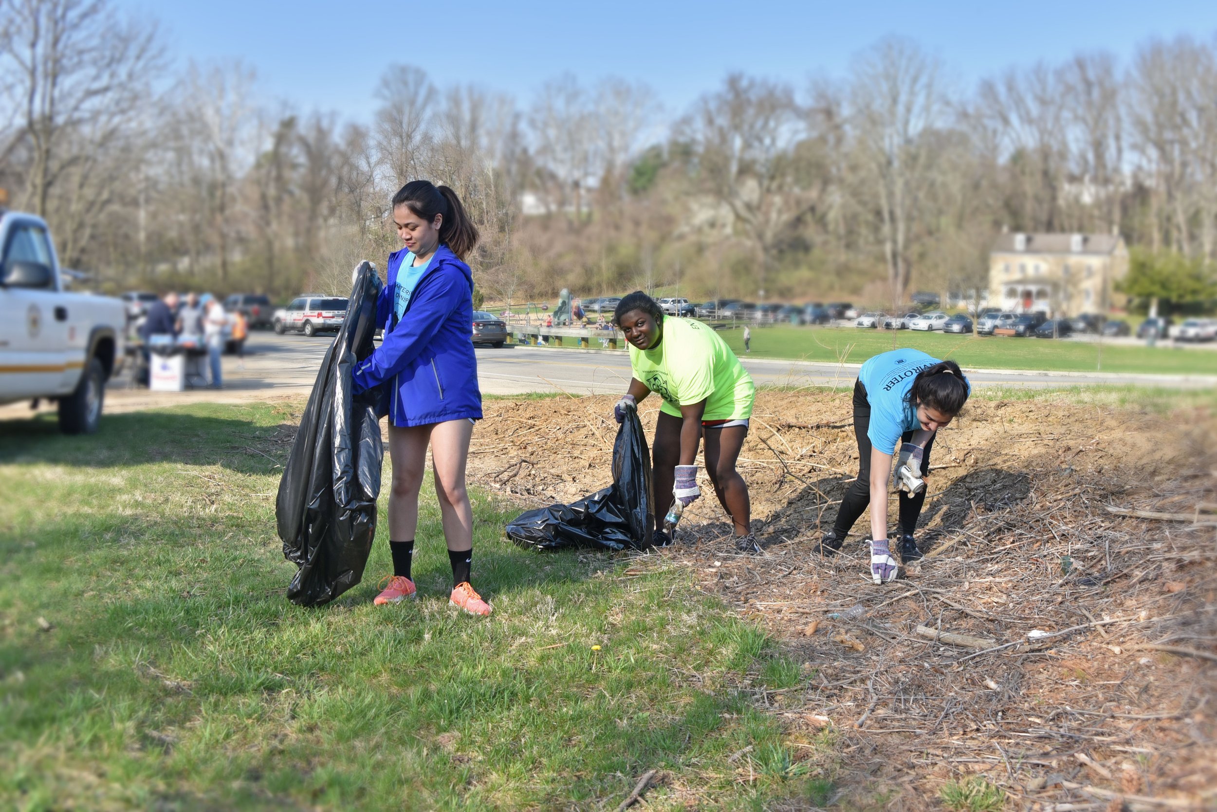 Members of the Conshohocken Plymouth Whitemarsh Club removing trash from the local park.