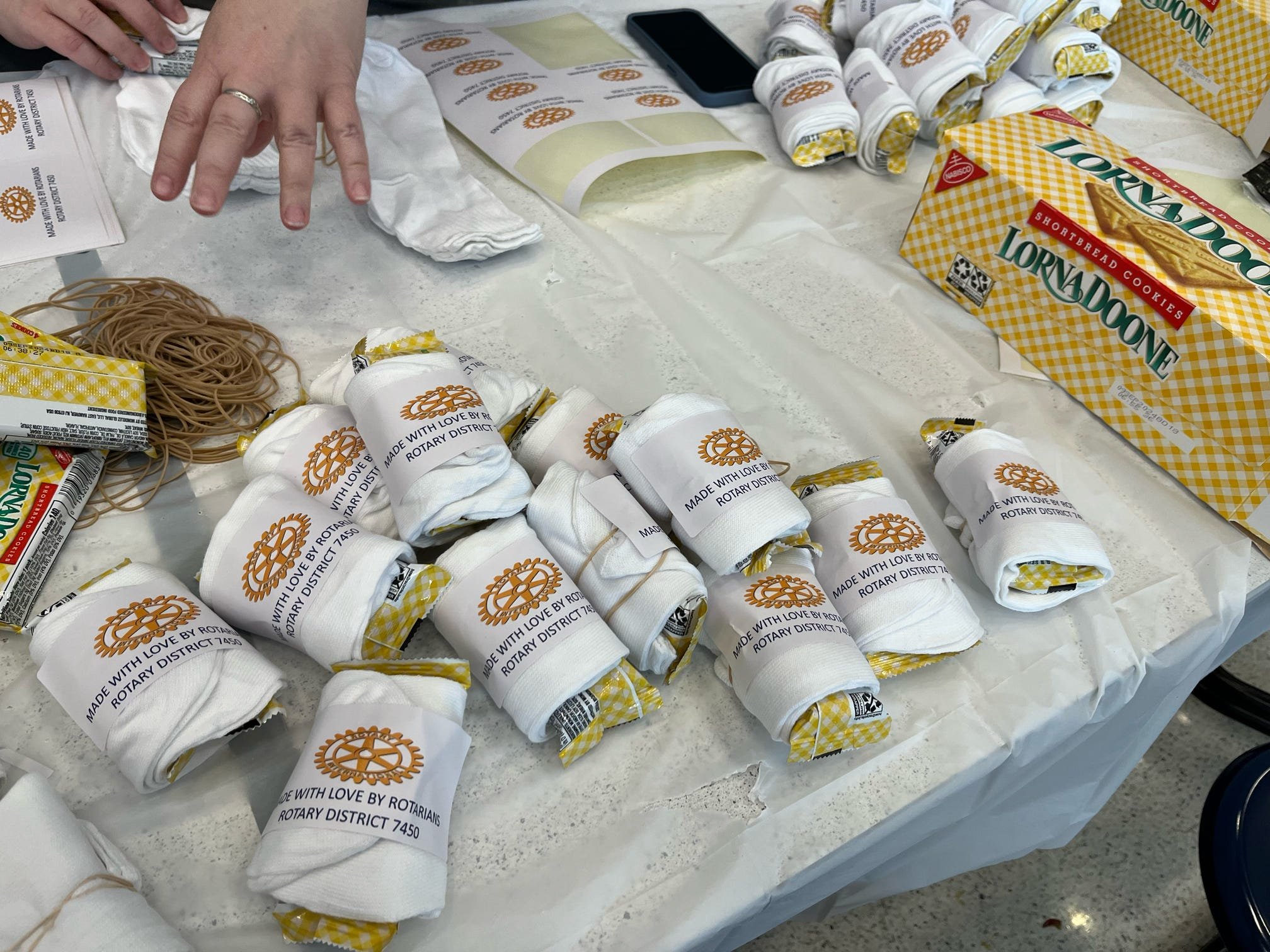 Assembling sock rolls for the unhoused, St. Vincent de Paul Society and the Grace Project.