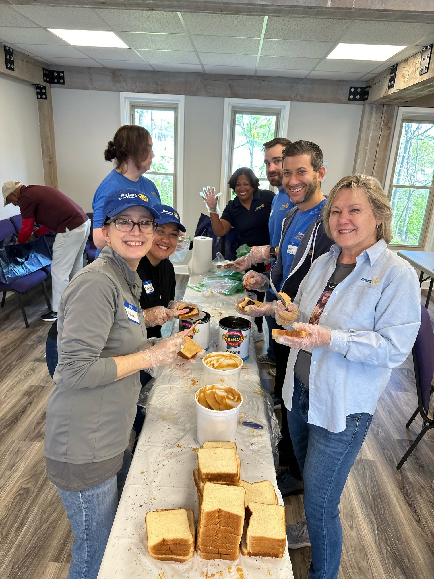 Volunteers preparing sandwiches for the unhoused as part of the District-wide service day involving 45 clubs in Southeastern PA.