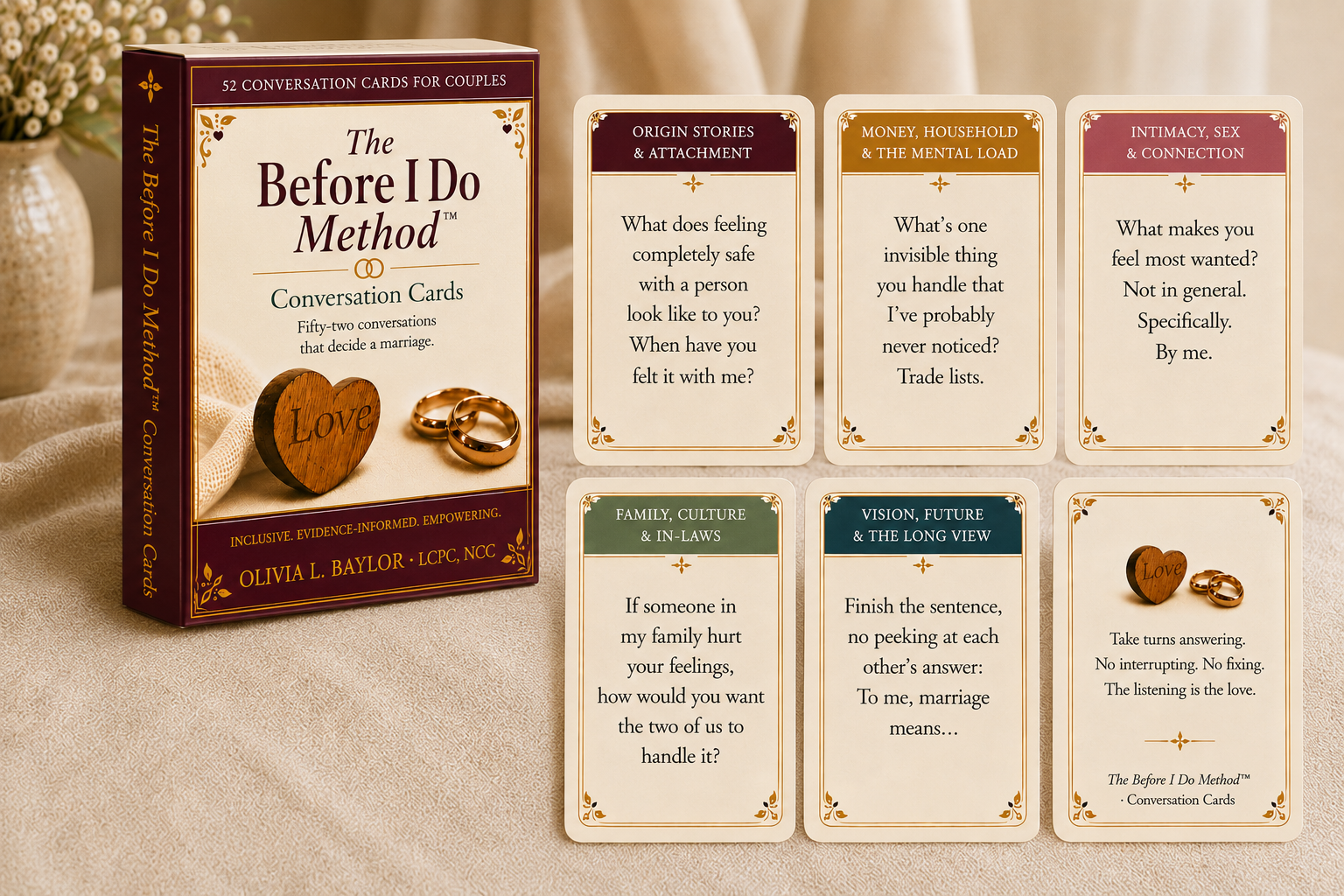 A box of conversation cards titled "The Before I Do Method" with 52 cards for couples. Four cards are laid out in front of the box, each featuring prompts for discussions about marriage, feelings, family, and the future. The box and cards are on a beige cloth surface with a vase of flowers in the background.