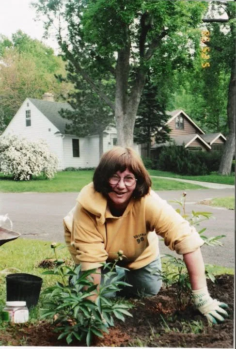 Jessica's mom planting new peonies from her daughter for Mother's Day in their family garden in Madison