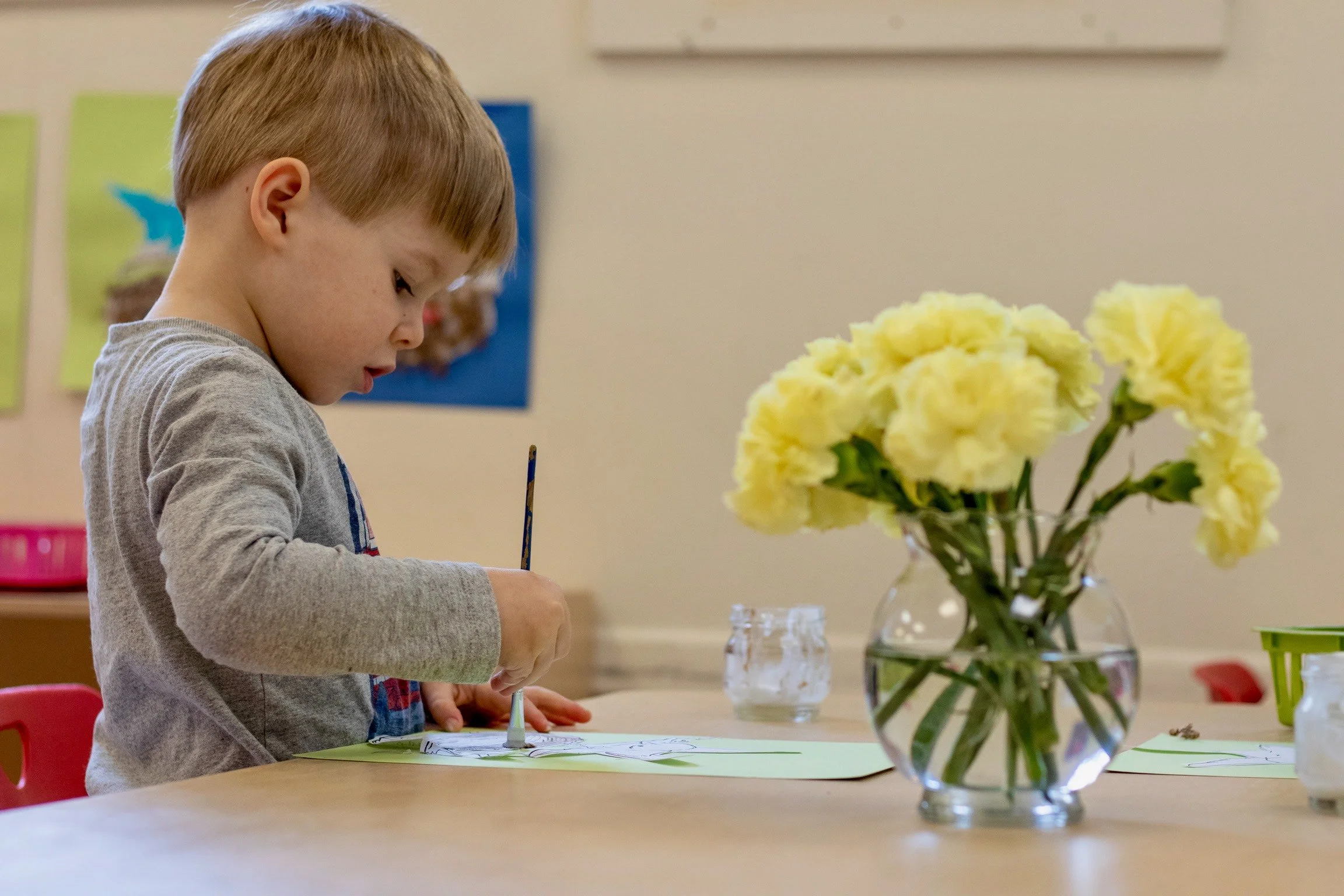 Toddler Boy Painting on Glue Art Project for Stepping Stones Program Independence at Little Crane Montessori School in Ridgewood, NJ Bergen County