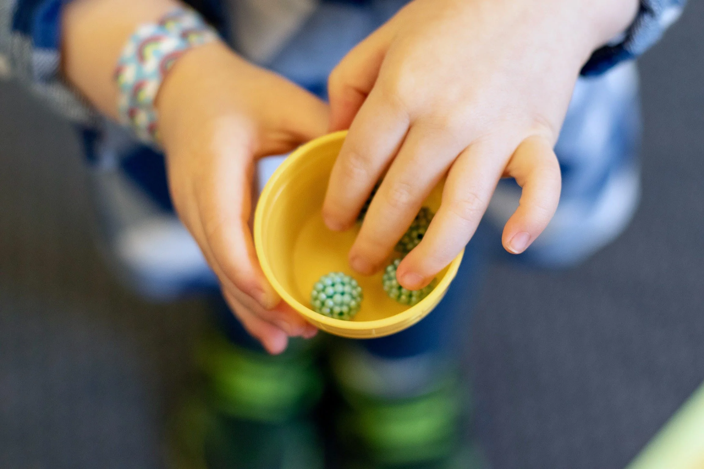 Stepping Stones Student working with small materials for sensorial at Little Crane Montessori School in Ridgewood, NJ Bergen County