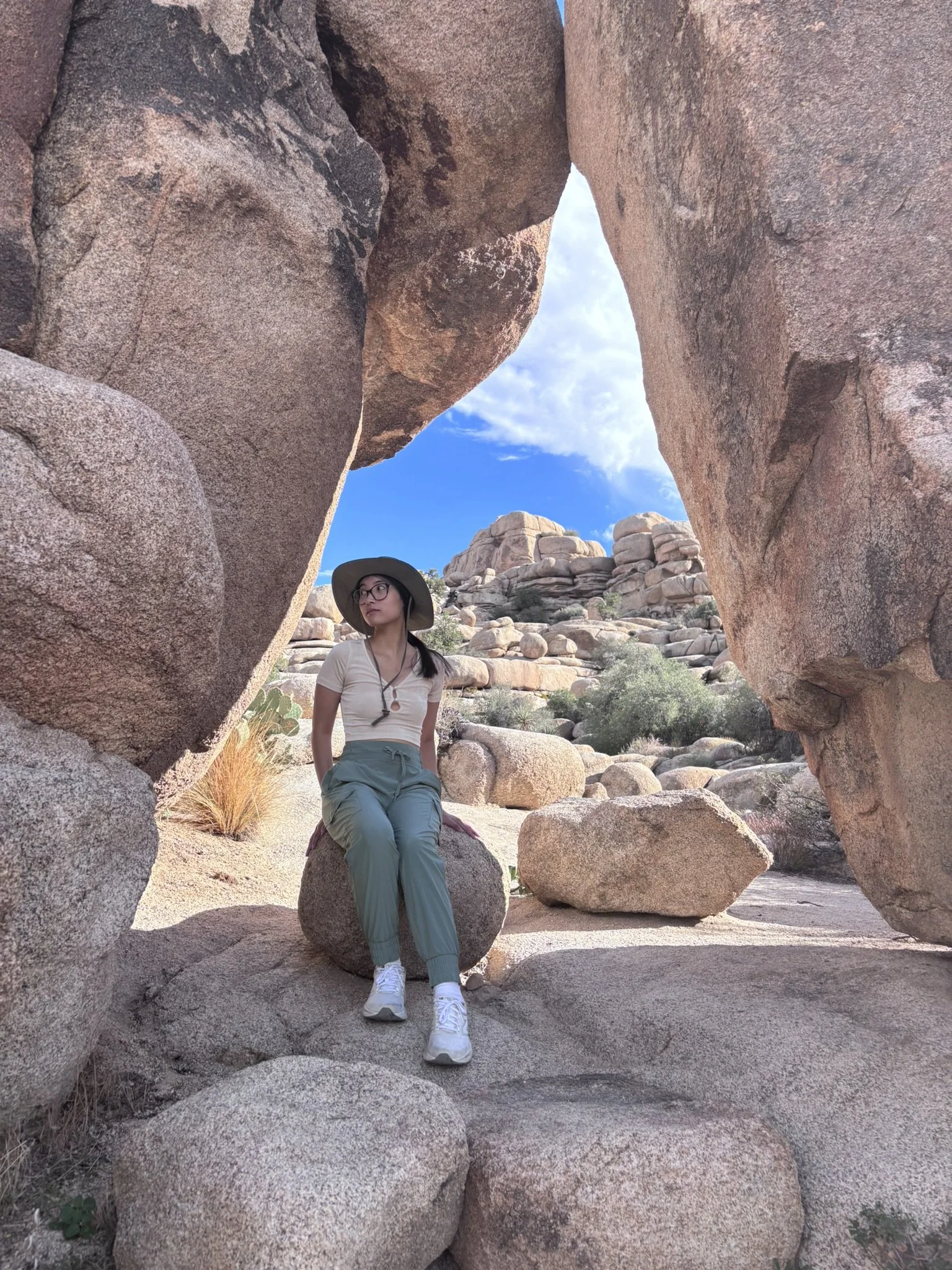 Photo of me sitting within a rock formation at Joshua Tree National Park