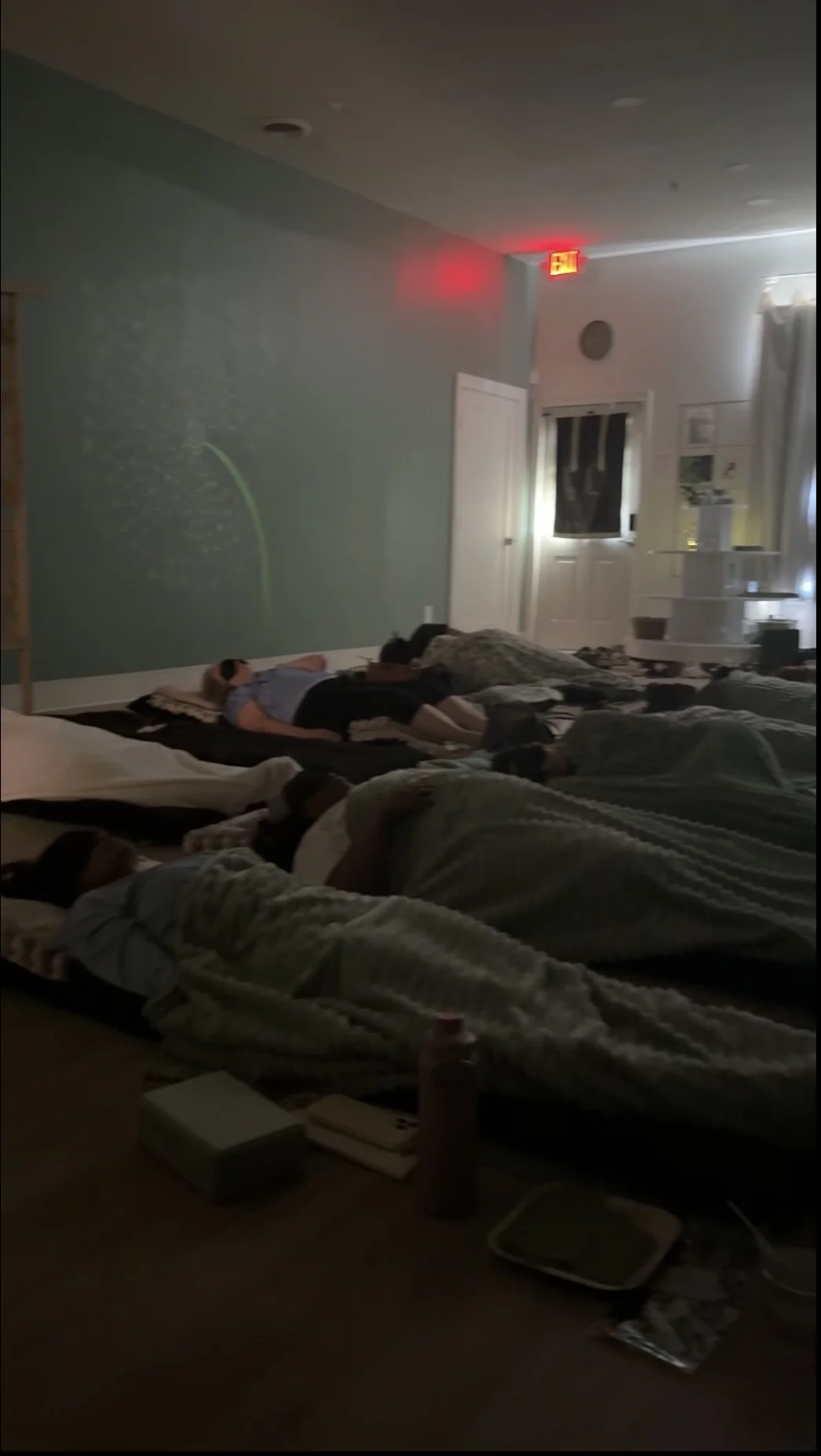 people comfortably laying on cushions during a sound bath