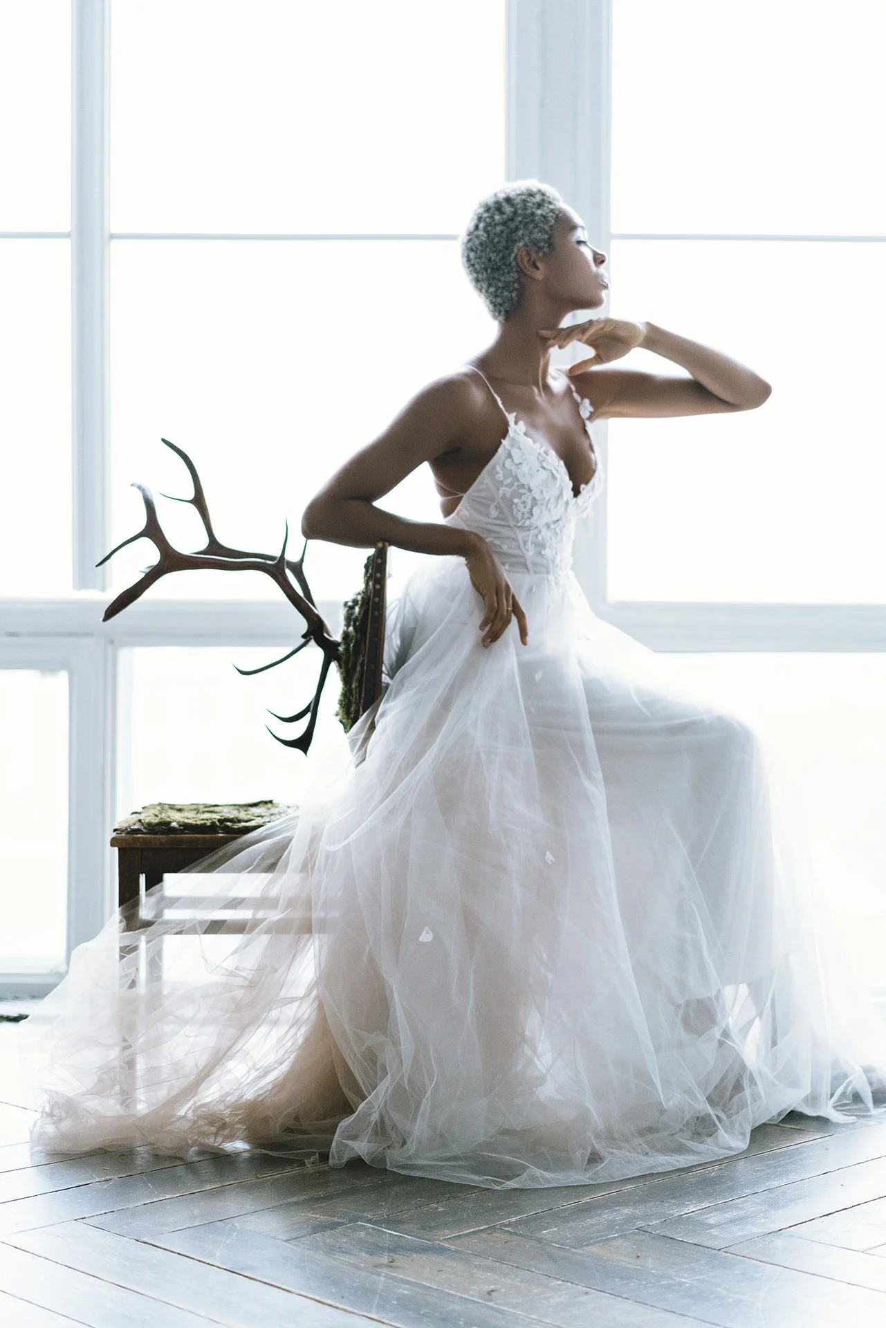 Editorial bridal photographer in Munich capturing African girl wearing wedding dress in photostudion in Munich