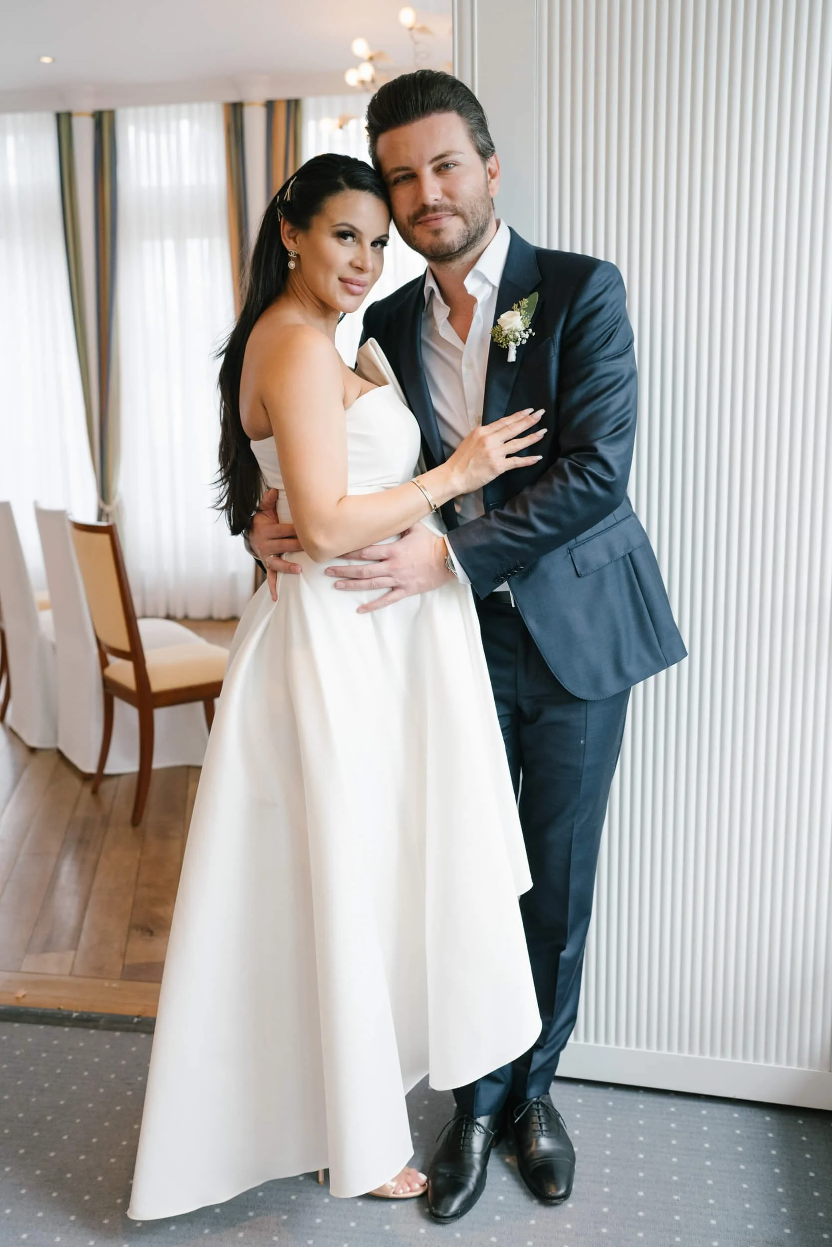 Wedding couple in bridal outfits hugging each other