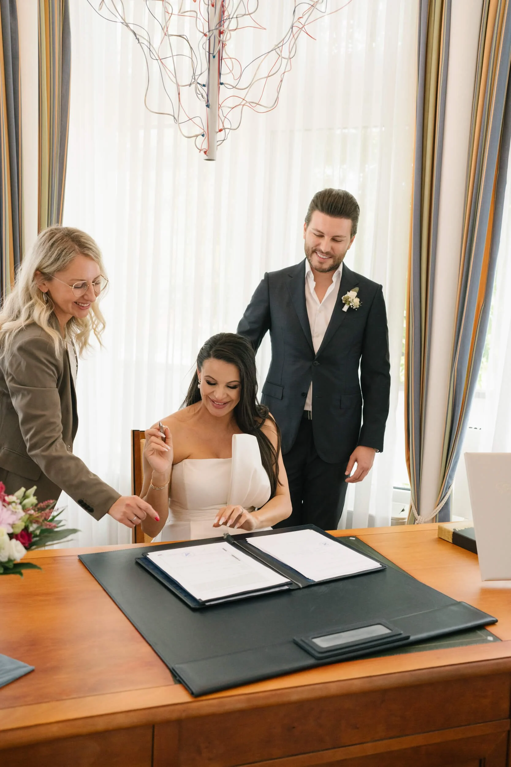 wedding couple signing documents during their civil wedding in Standesamt Grunwald