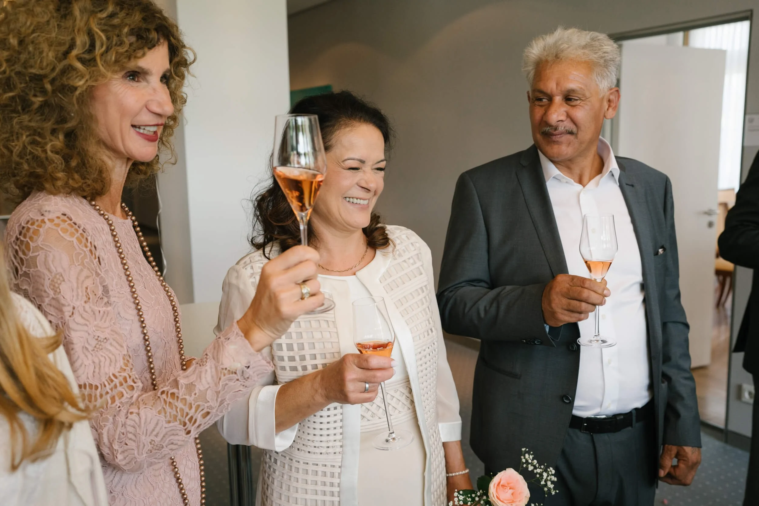 happy guests with glass of champagne in Standesamt Grunwald